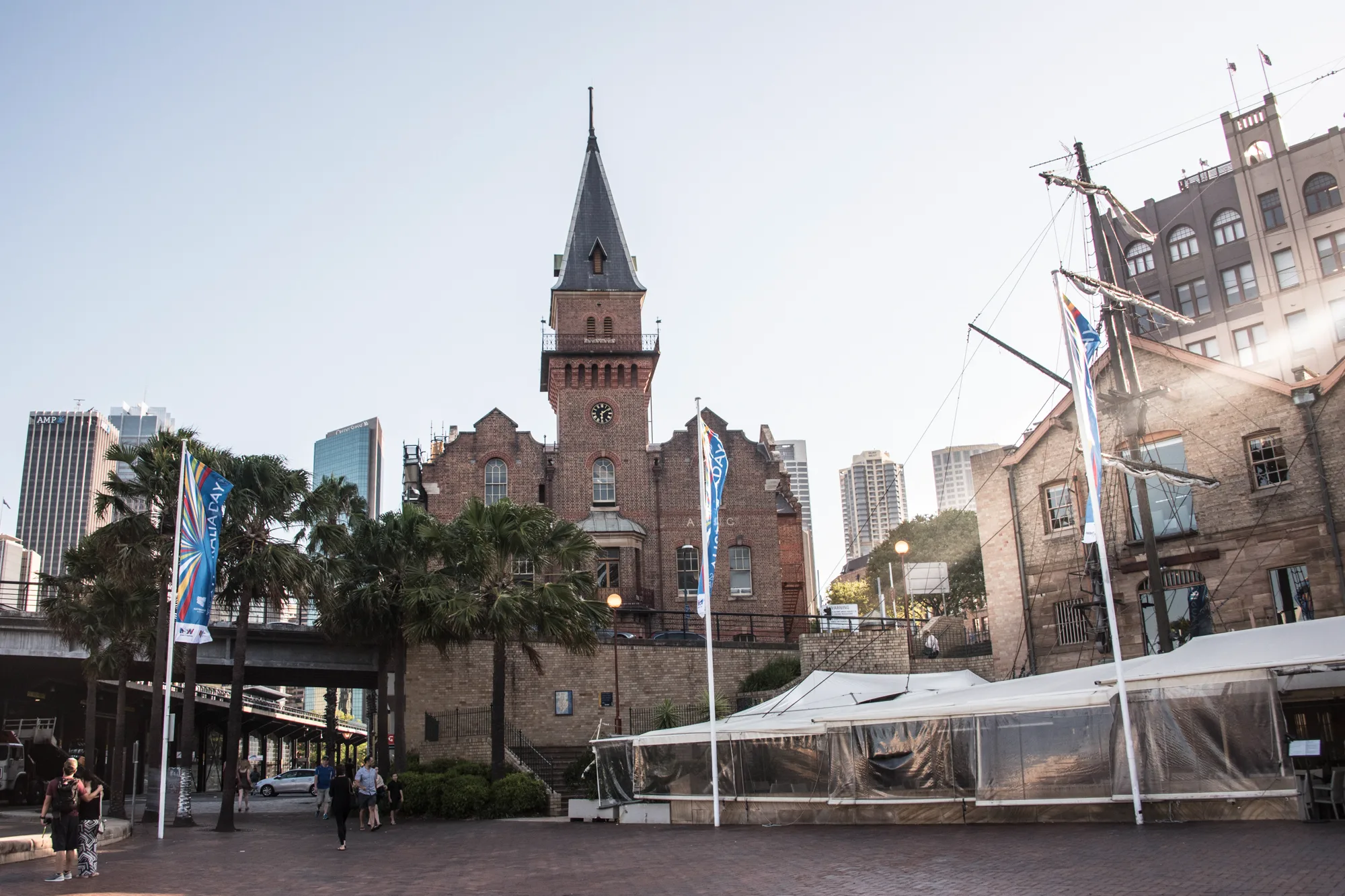 Historic red-brick clock tower among palms and high-rises at The Rocks, Sydney — Australia, travel and fine art photography by Janina Laszlo