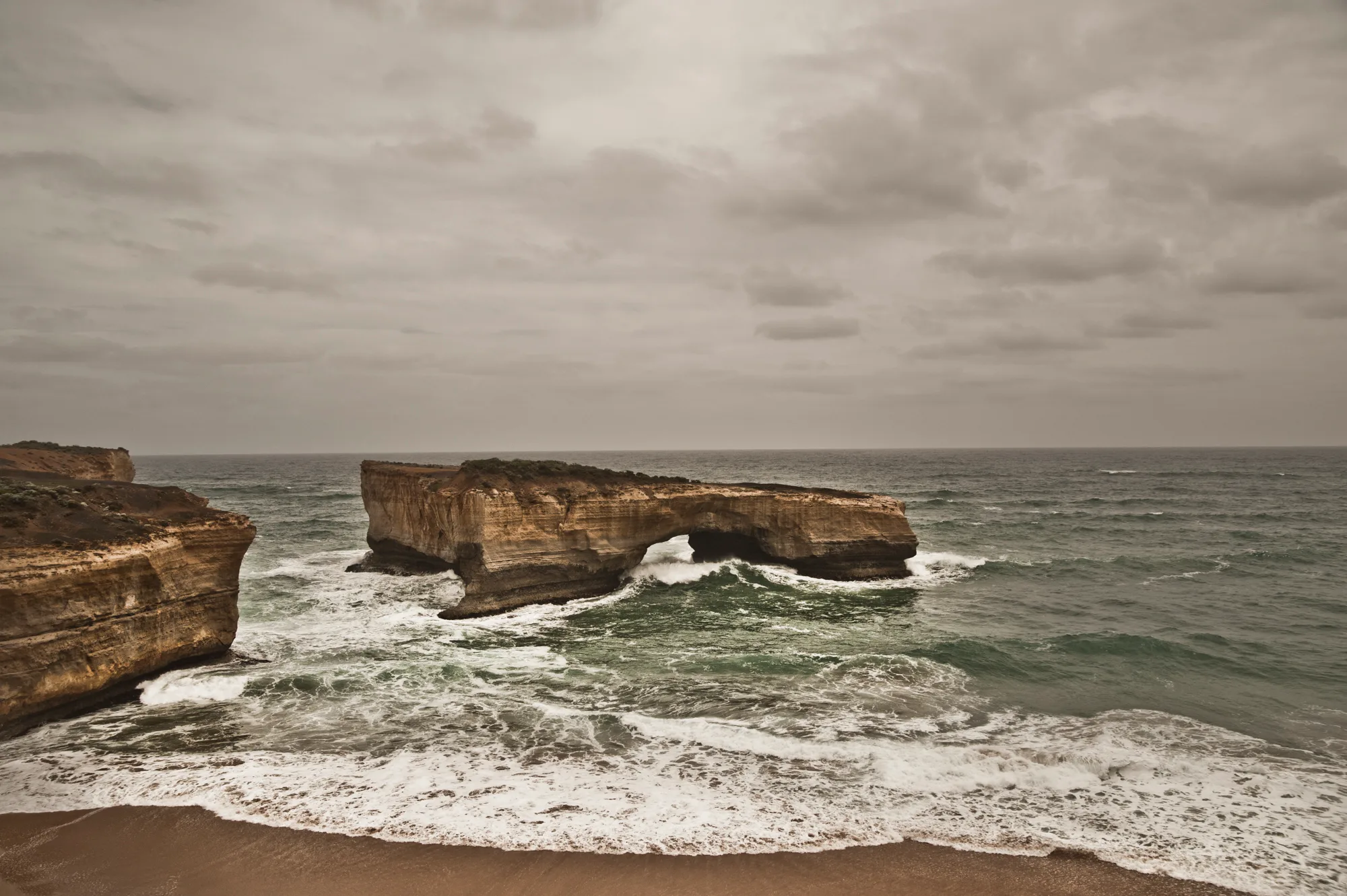 The sea arch London Bridge in rough surf, Great Ocean Road, Victoria — Australia, travel and fine art photography by Janina Laszlo