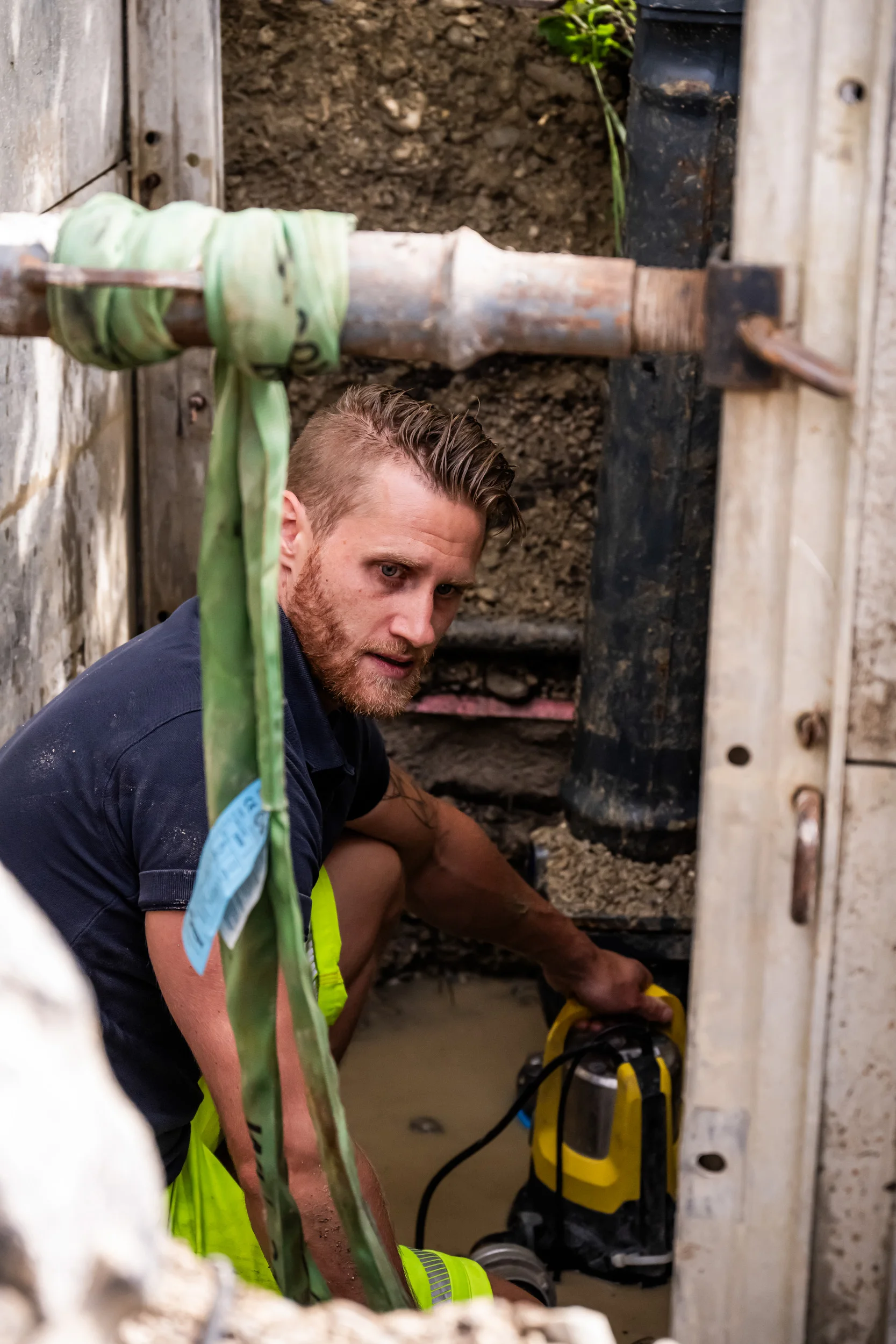 Technician working in a shored excavation on a water main — AWA Ammersee, industrial, corporate and portrait photography by Janina Laszlo