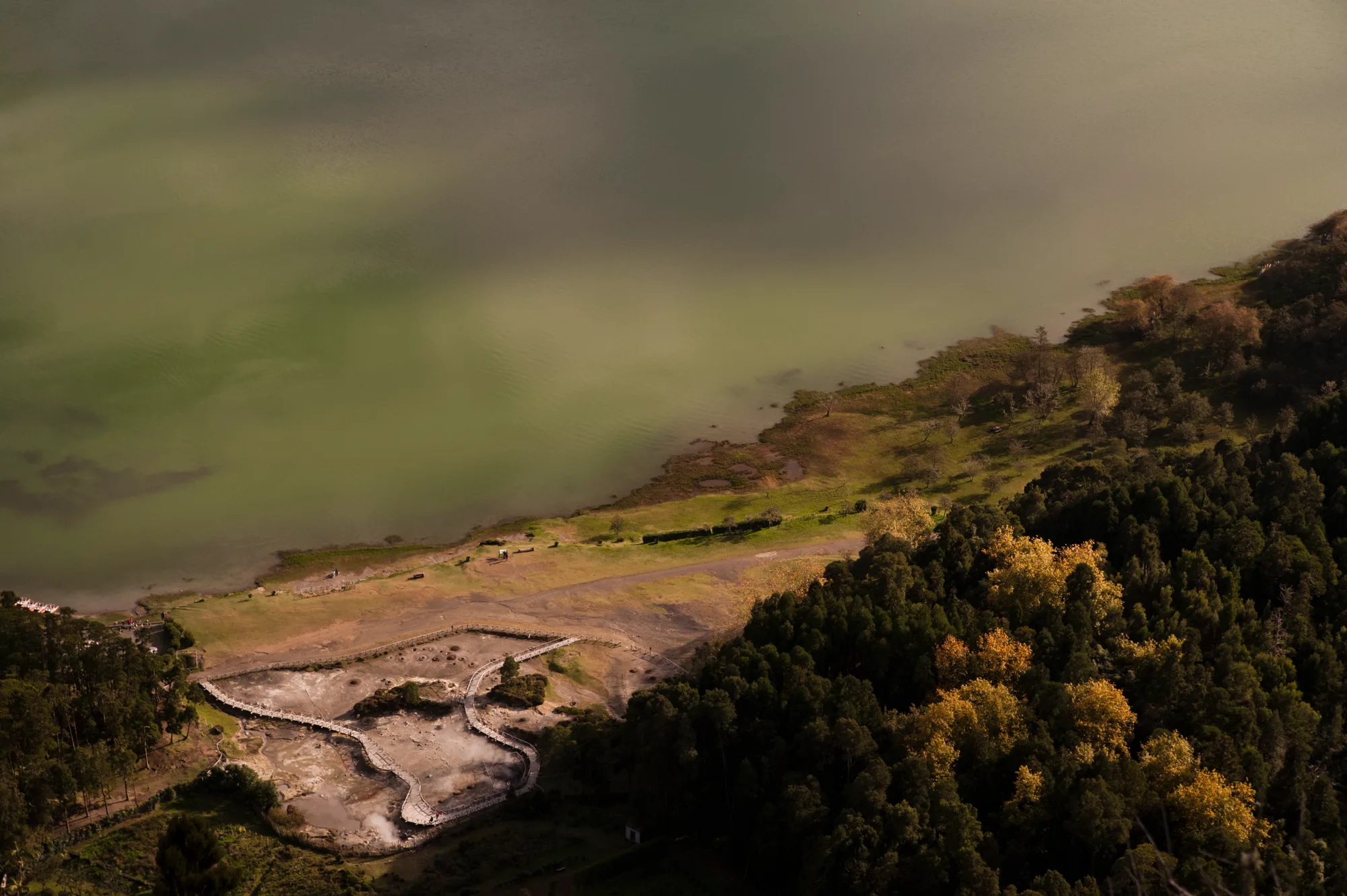 Lagoa das Furnas seen from above with steaming fumaroles and boardwalks on its shore — Azores, São Miguel, travel and fine art photography by Janina Laszlo