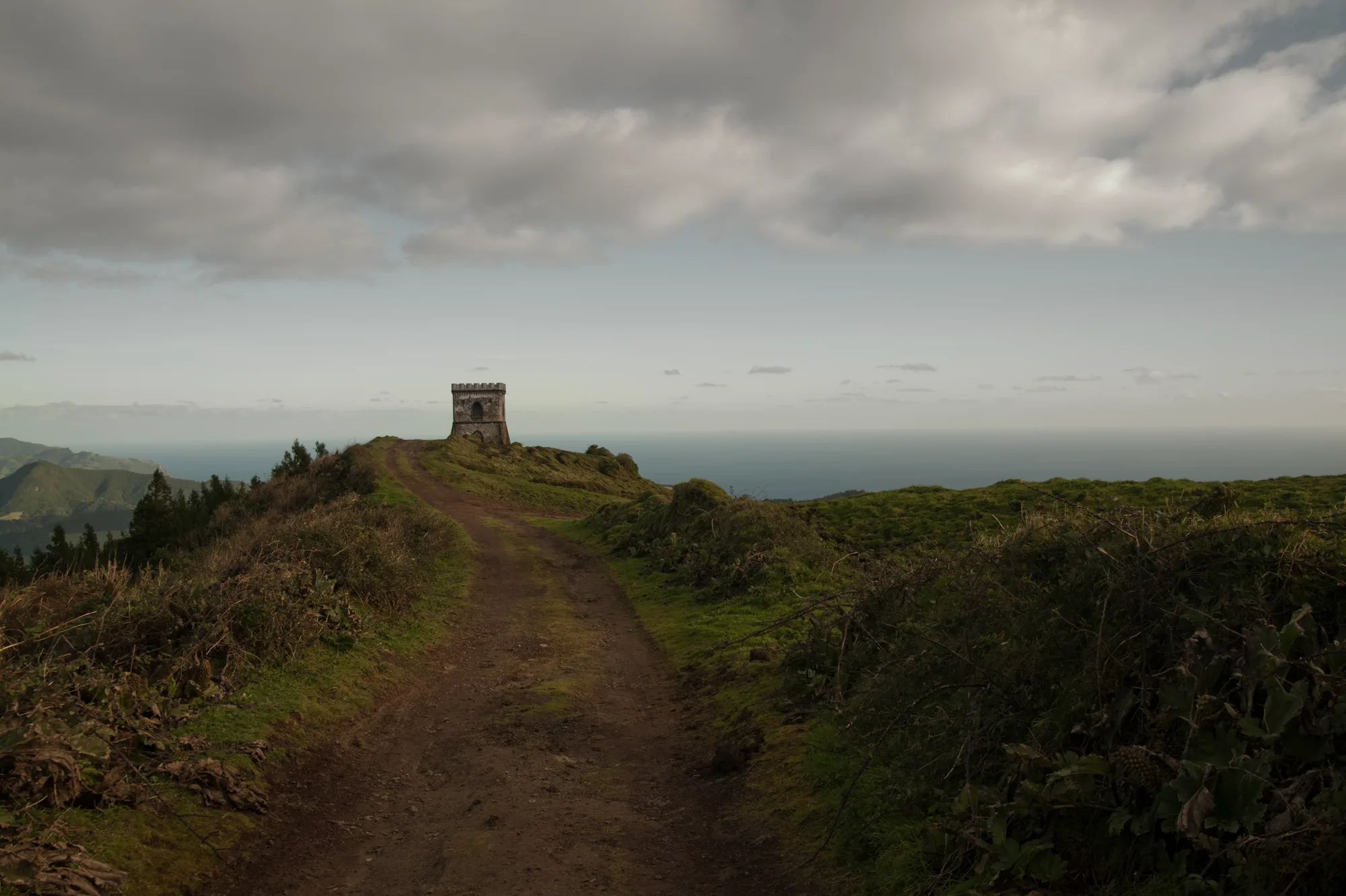 Stone lookout tower at the end of a ridge track high above the ocean — Azores, São Miguel, travel and fine art photography by Janina Laszlo