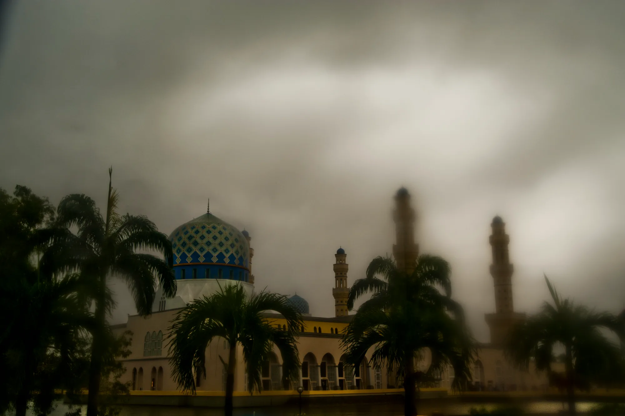 Kota Kinabalu City Mosque with its blue dome and minarets in mist and rain, Kota Kinabalu, Sabah — Borneo & Pulau Mabul, documentary and travel photography by Janina Laszlo