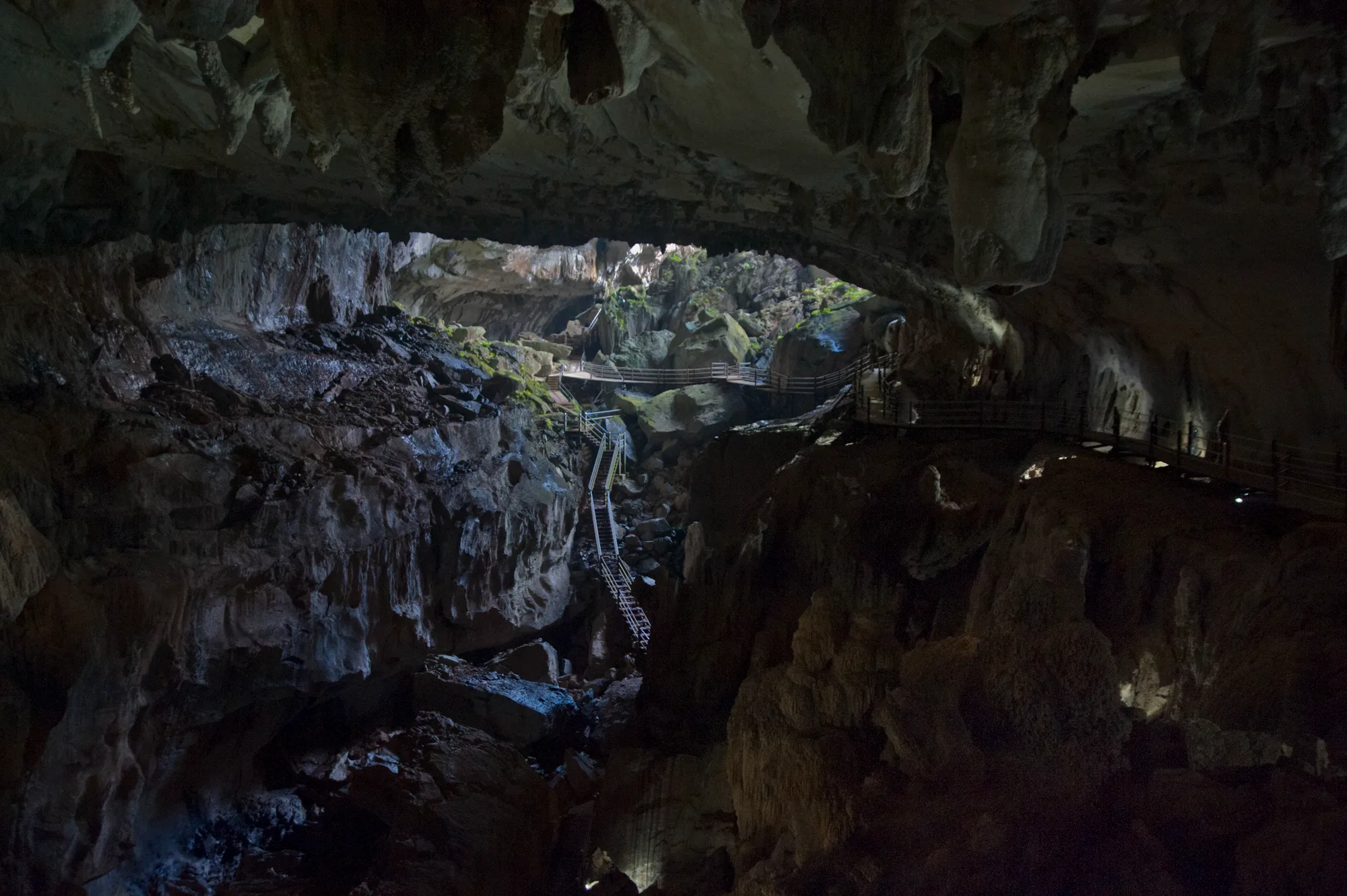 Vast cave chamber with wooden walkways and stairs — Borneo & Pulau Mabul, documentary and travel photography by Janina Laszlo