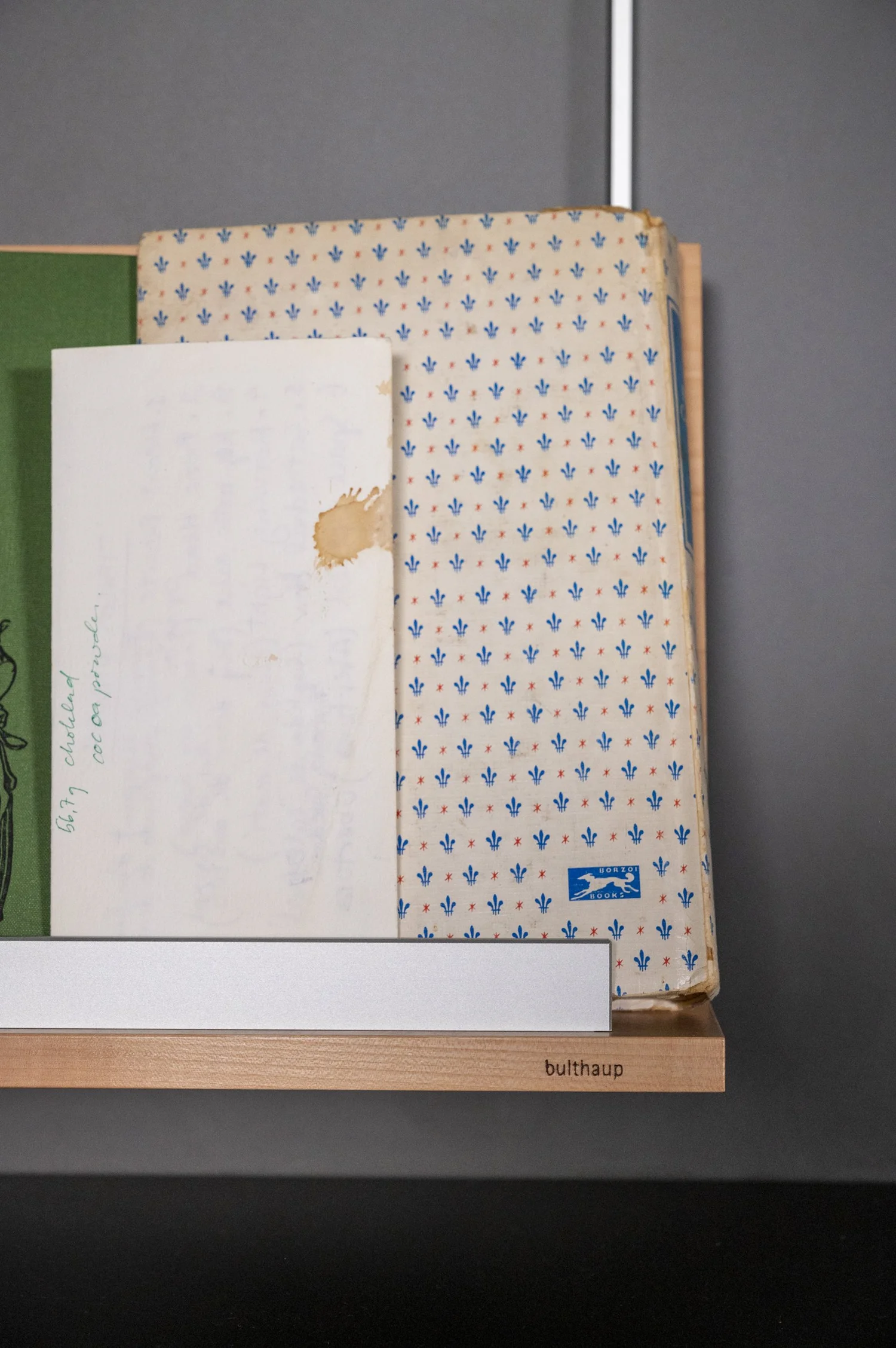 Stacked cutting boards and linen in an open bulthaup drawer, product detail — campaign photography by Janina Laszlo, Munich