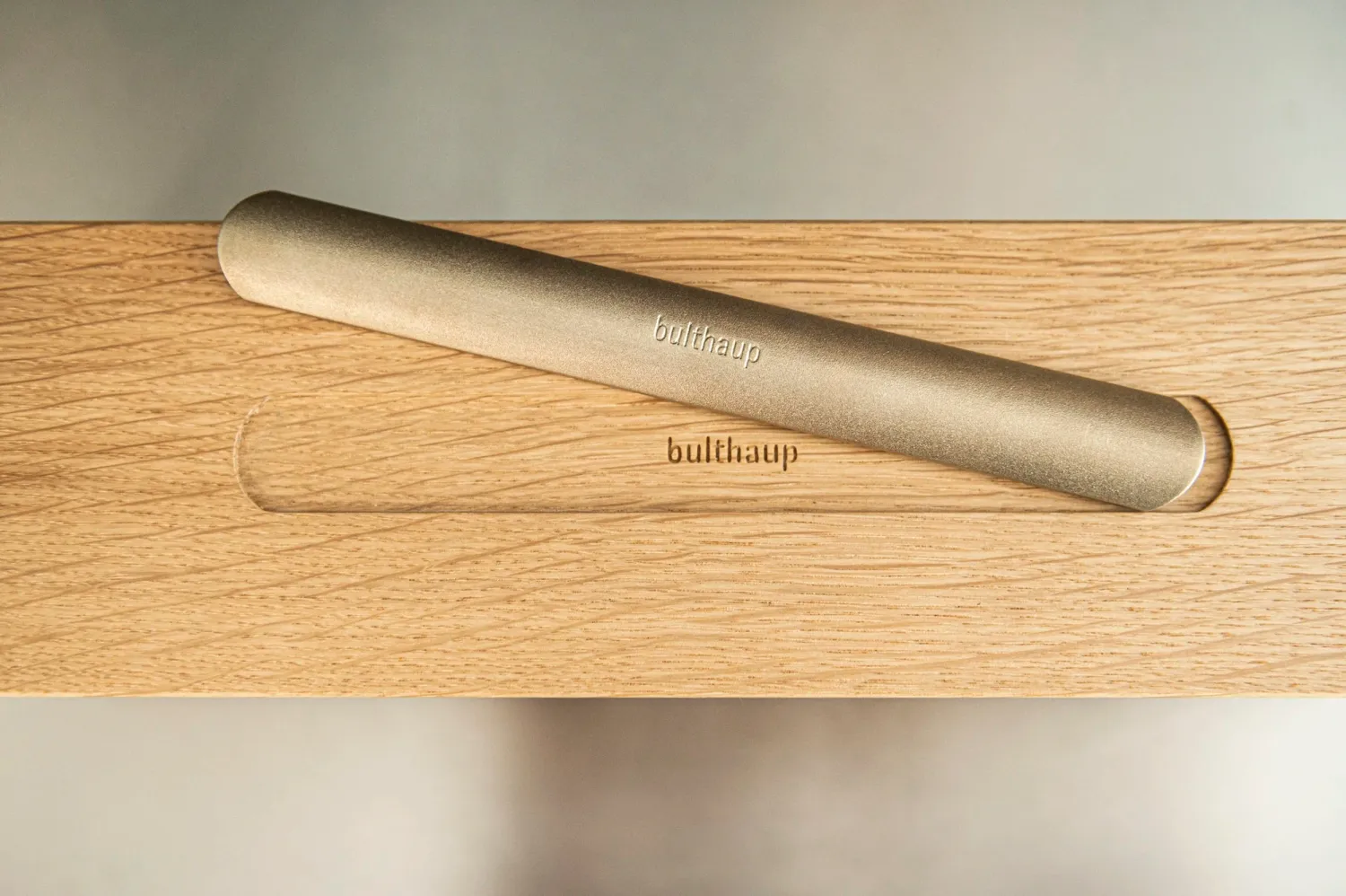 Oak tray with inset metal rolling pin, bulthaup accessory detail — campaign photography by Janina Laszlo, Munich