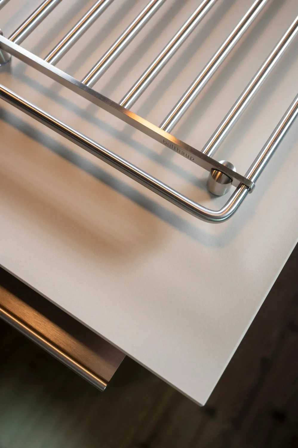 Stainless steel grid insert, bulthaup kitchen detail — campaign photography by Janina Laszlo, Munich
