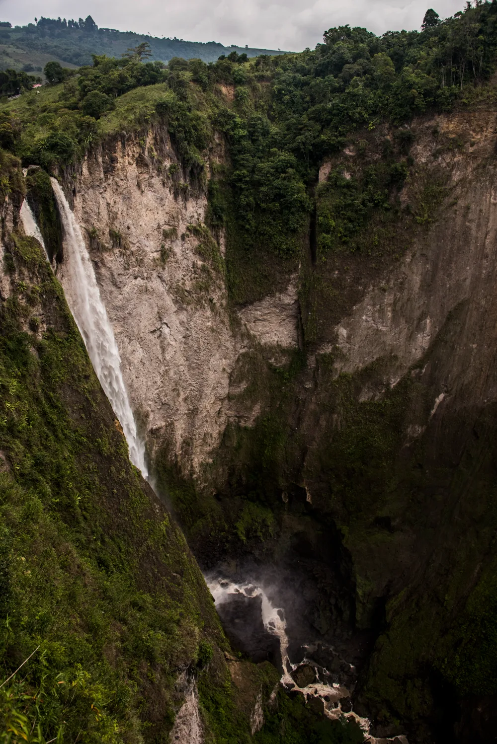 Waterfall plunging into a deep green gorge — Colombia, travel and documentary photography by Janina Laszlo