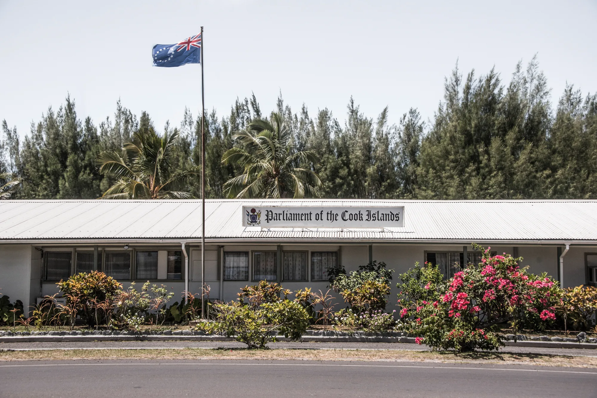 Parliament of the Cook Islands with flag and bougainvillea, Avarua, Rarotonga — Cook Islands, travel and fine art photography by Janina Laszlo