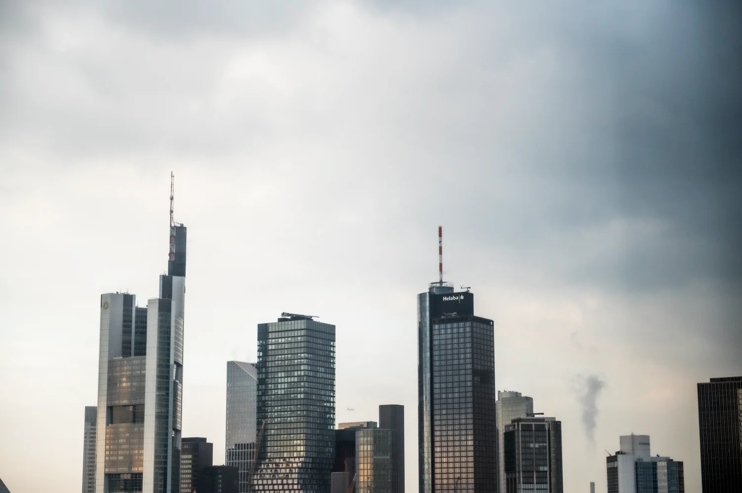 Frankfurt banking skyline with Commerzbank Tower and Main Tower under dark clouds, Frankfurt am Main — Digital+, corporate photography by Janina Laszlo