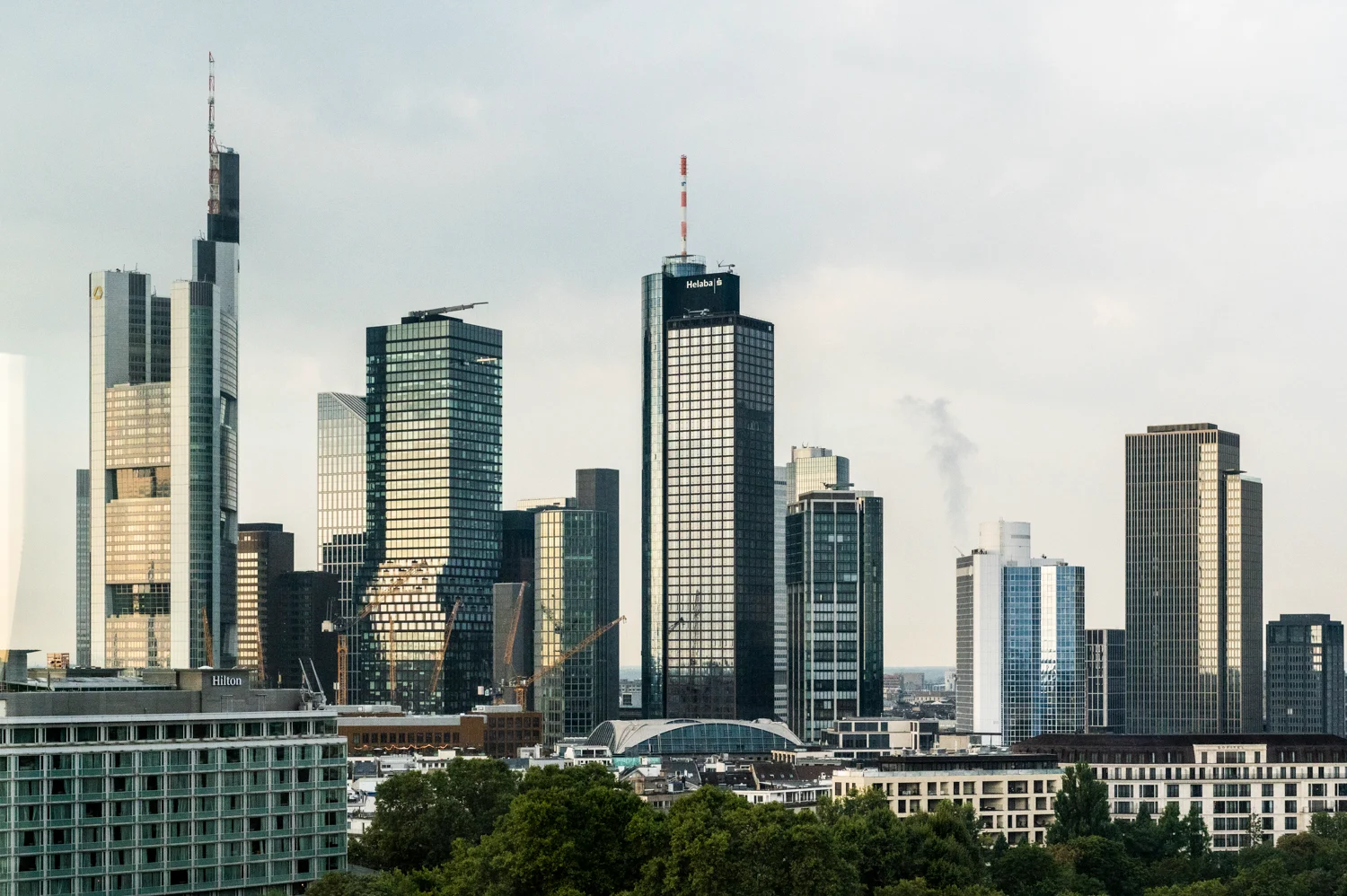 Frankfurt banking skyline with Commerzbank Tower, Main Tower and the Helaba sign, seen from the Digital+ office, Frankfurt am Main — Digital+, corporate photography by Janina Laszlo