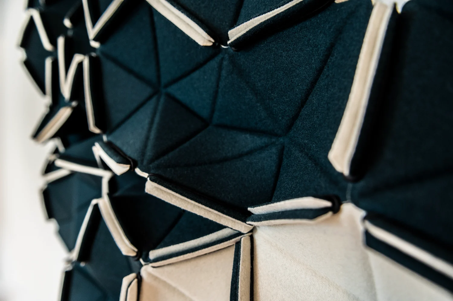 Close-up of a dark green and cream folded felt acoustic wall panel, Frankfurt am Main — Digital+, corporate photography by Janina Laszlo