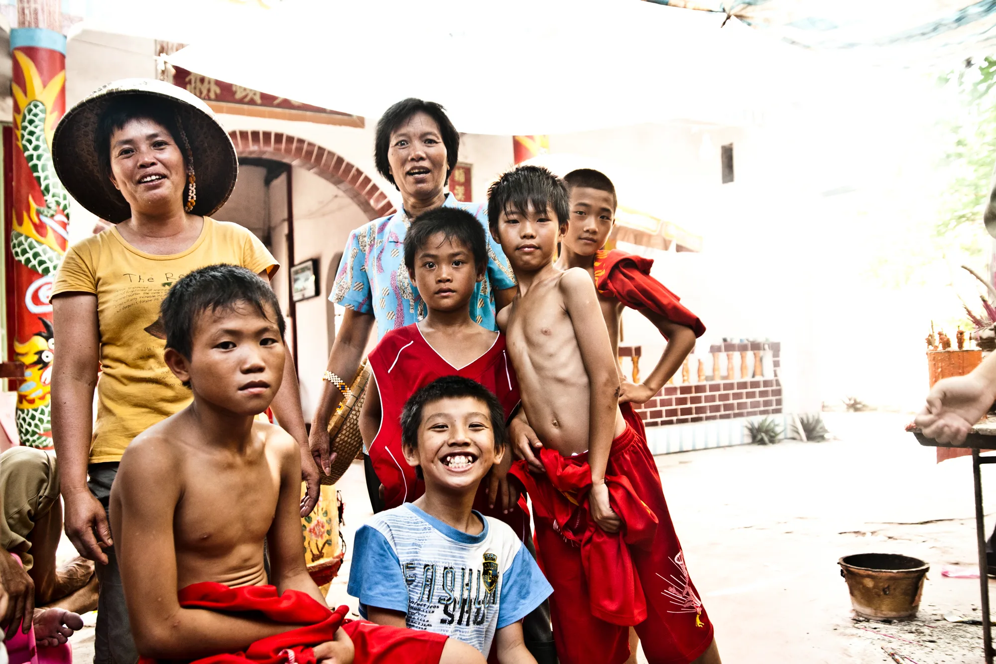 Villagers and children gathered on a sunny square — Dragon Boat Festival Hainan, documentary photography by Janina Laszlo