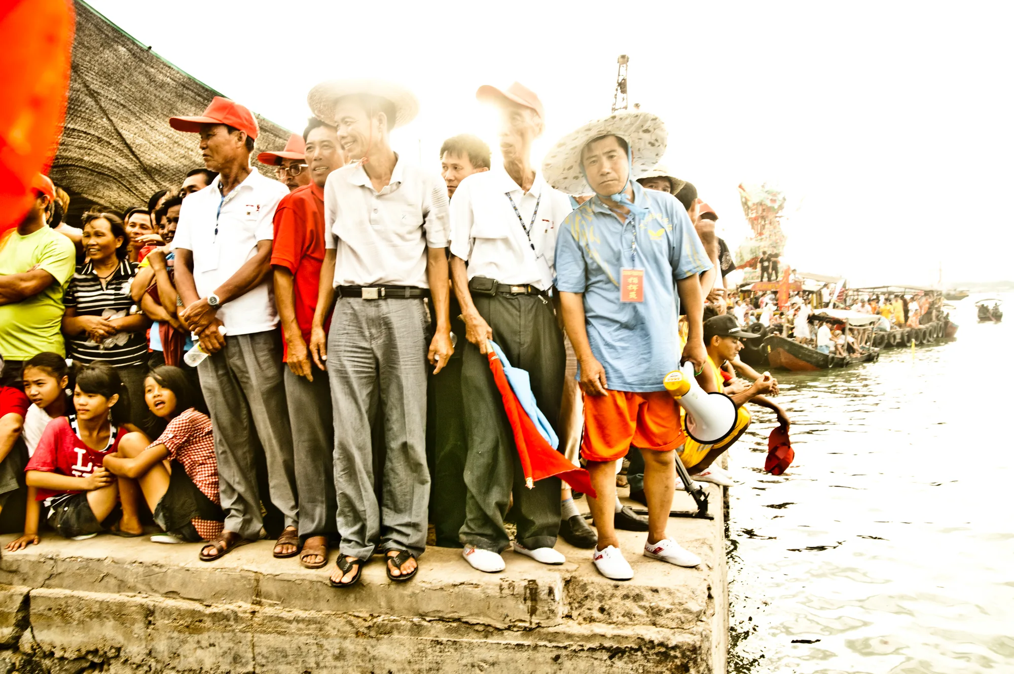 Spectators and officials at the edge of the pier — Dragon Boat Festival Hainan, documentary photography by Janina Laszlo