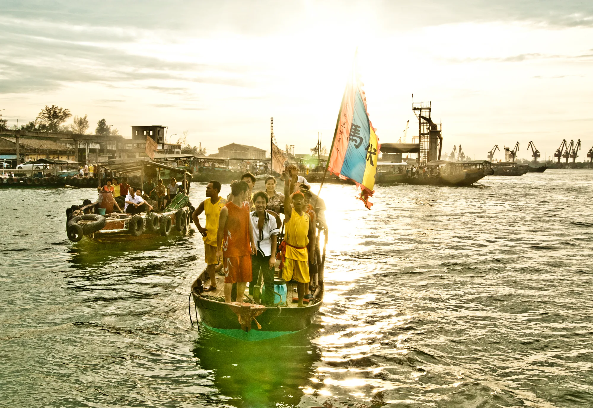 Festival boat with costumed crew in backlight — Dragon Boat Festival Hainan, documentary photography by Janina Laszlo