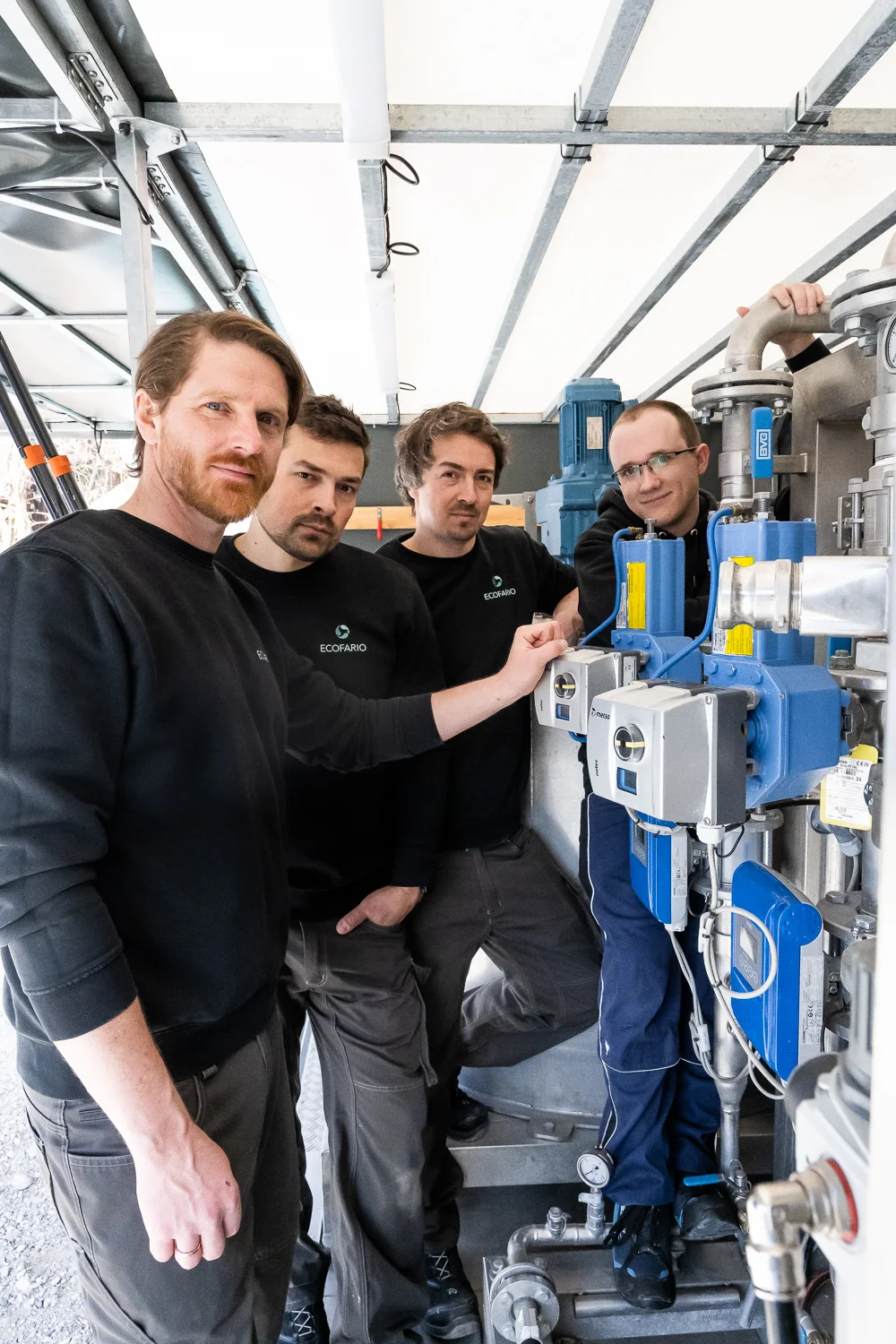 ECOFARIO team in black work shirts in the container workshop — ECOFARIO, corporate portrait and industrial reportage photography by Janina Laszlo