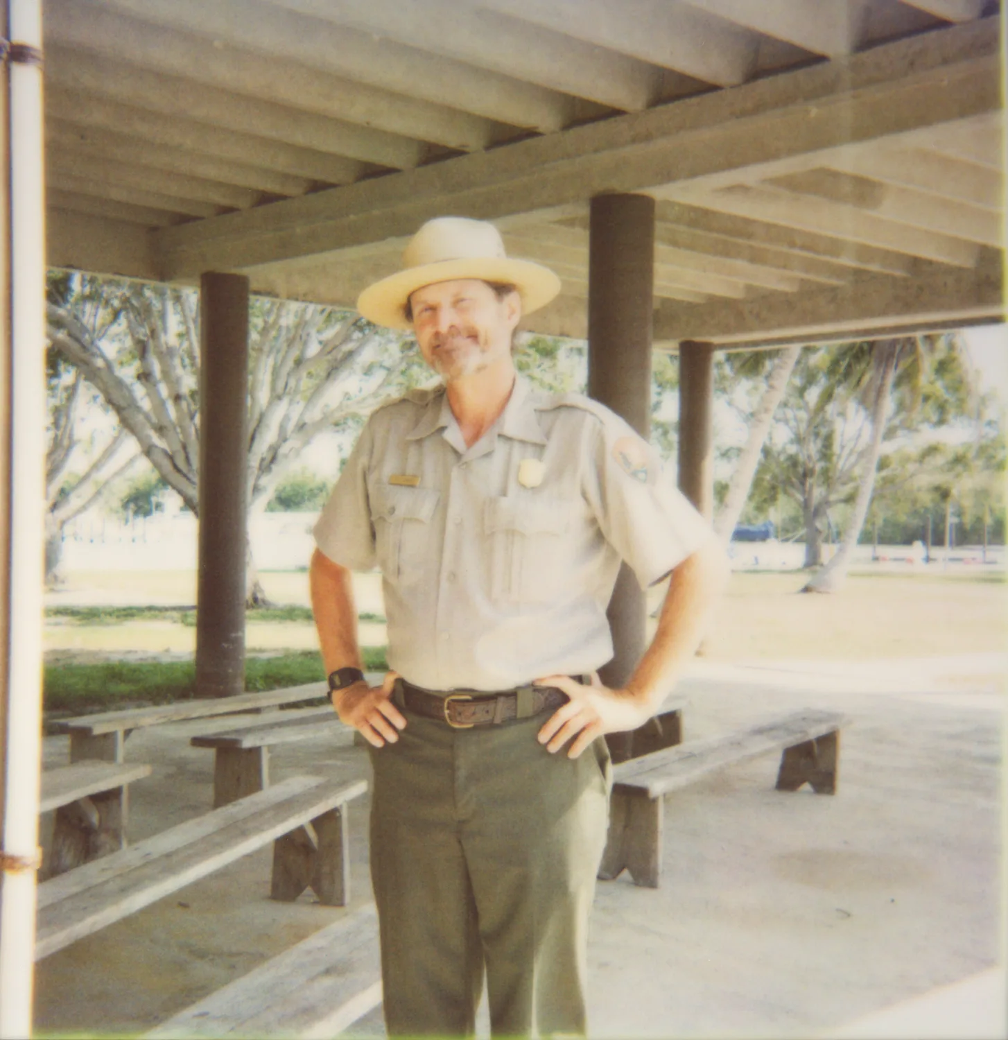 Park ranger in hat and uniform under a pavilion — Expired Polaroids in Florida, fine art and analog photography by Janina Laszlo