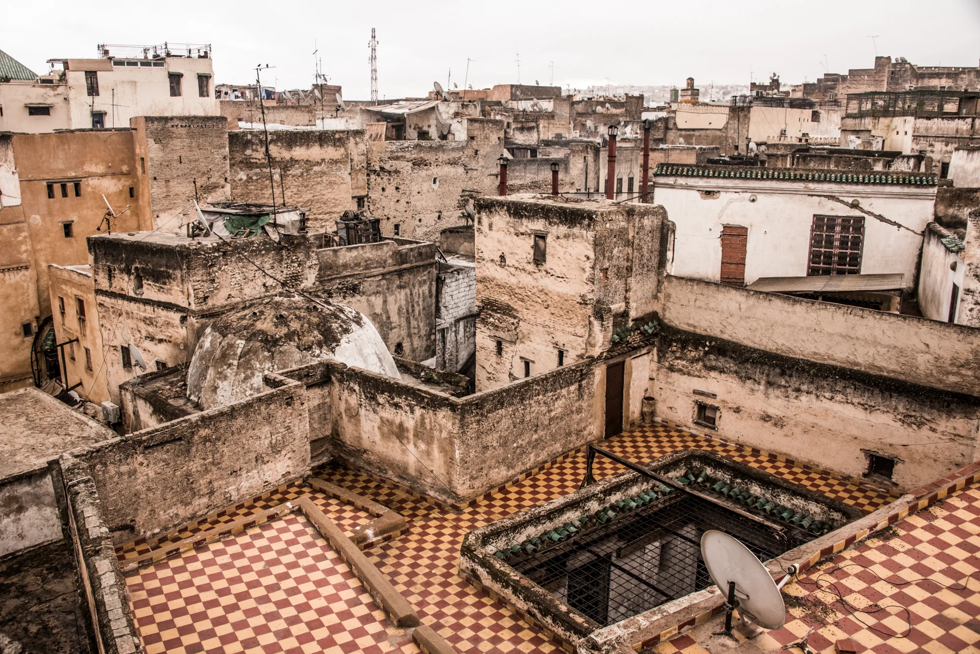 Rooftop terrace with checkered tiles above the old houses of the medina, Fez — Fez, street and travel photography by Janina Laszlo