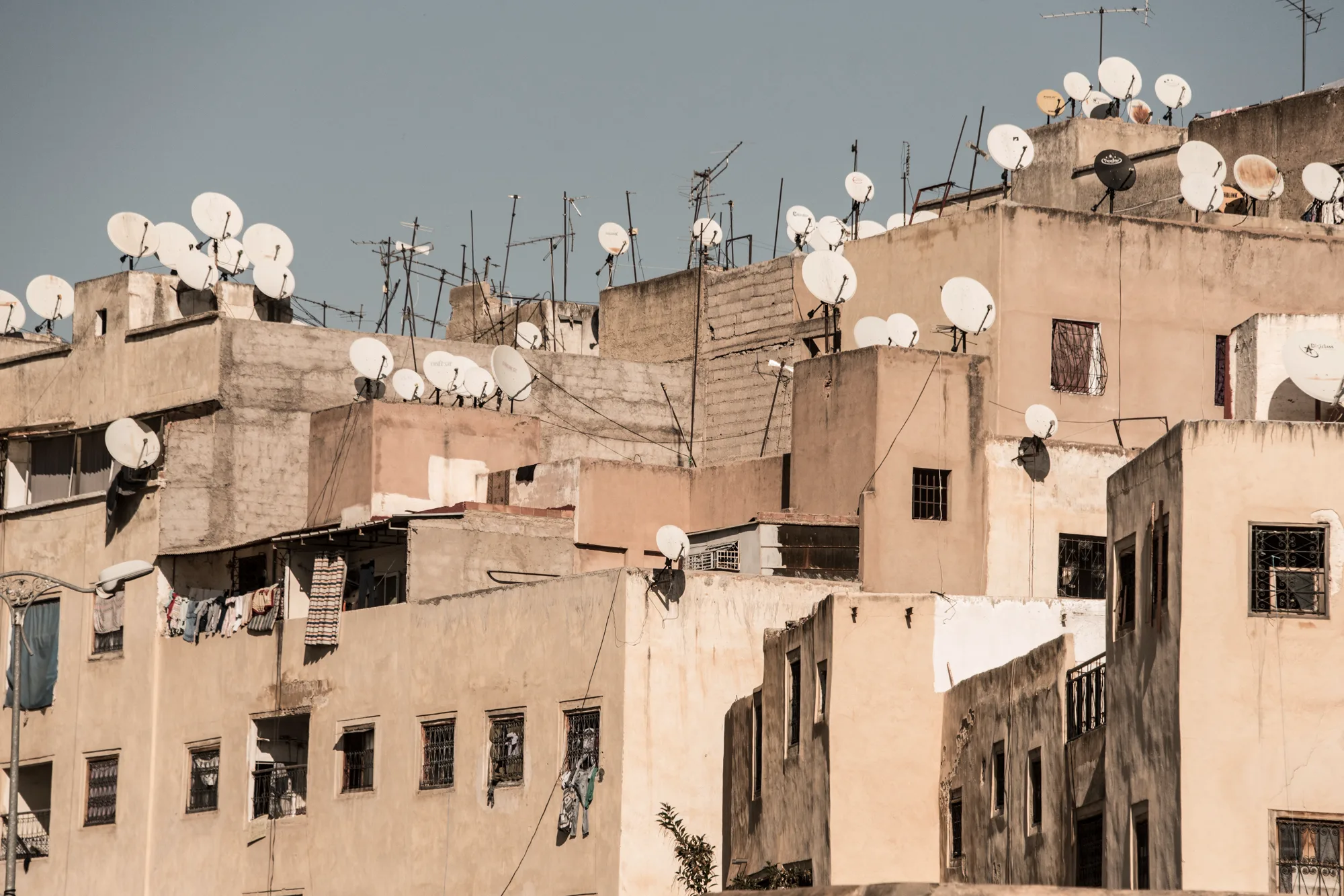 Satellite dishes crowding the rooftops of ochre apartment blocks, Fez — Fez, street and travel photography by Janina Laszlo