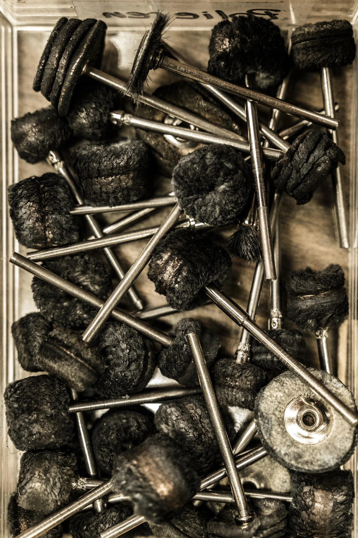 Box of black polishing wheels and burrs, still life of goldsmith tools — reportage by Janina Laszlo, photographer in Munich