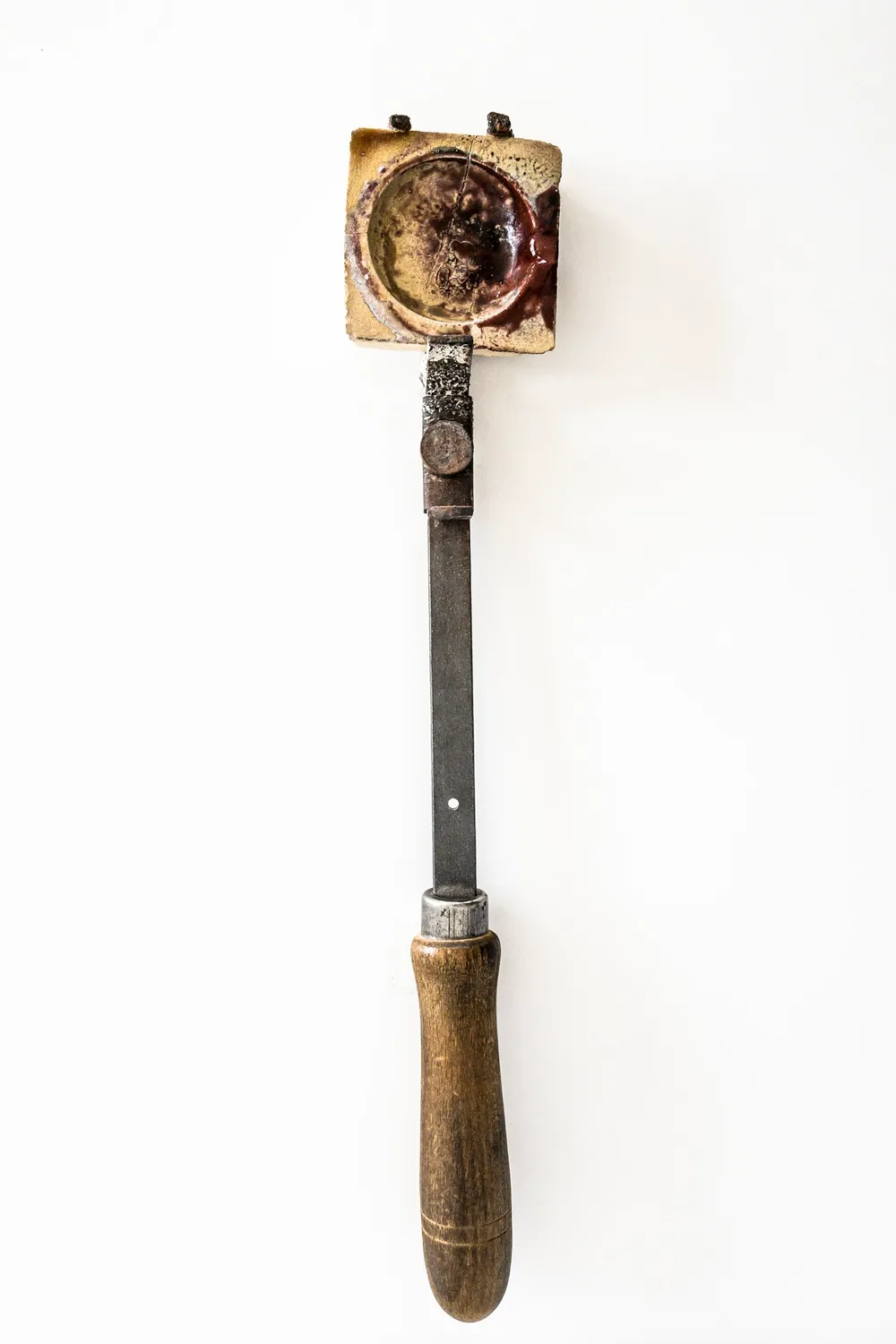 Antique hand drill hanging on a white wall — goldsmith Gerd Weickmann — reportage by Janina Laszlo, photographer in Munich