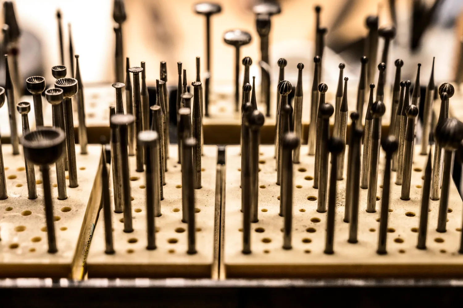 Rows of burrs and polishing bits in a wooden stand — goldsmith Gerd Weickmann — reportage by Janina Laszlo, photographer in Munich
