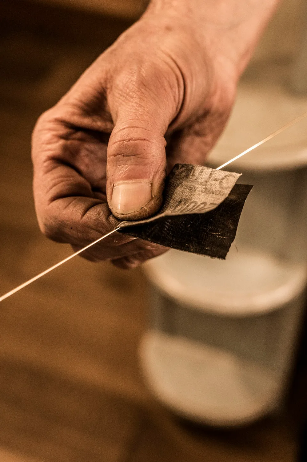 Hand drawing gold wire through a draw plate — goldsmith Gerd Weickmann — reportage by Janina Laszlo, photographer in Munich