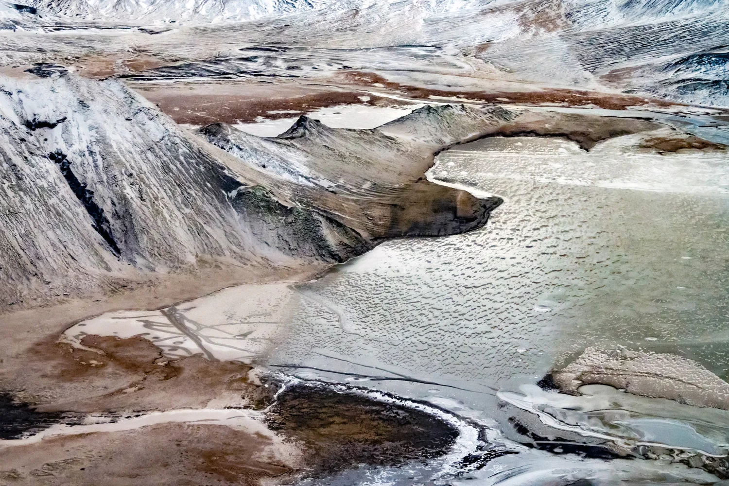 Braided river delta in beige and white tones seen from a plane over Iceland — travel photography by Janina Laszlo