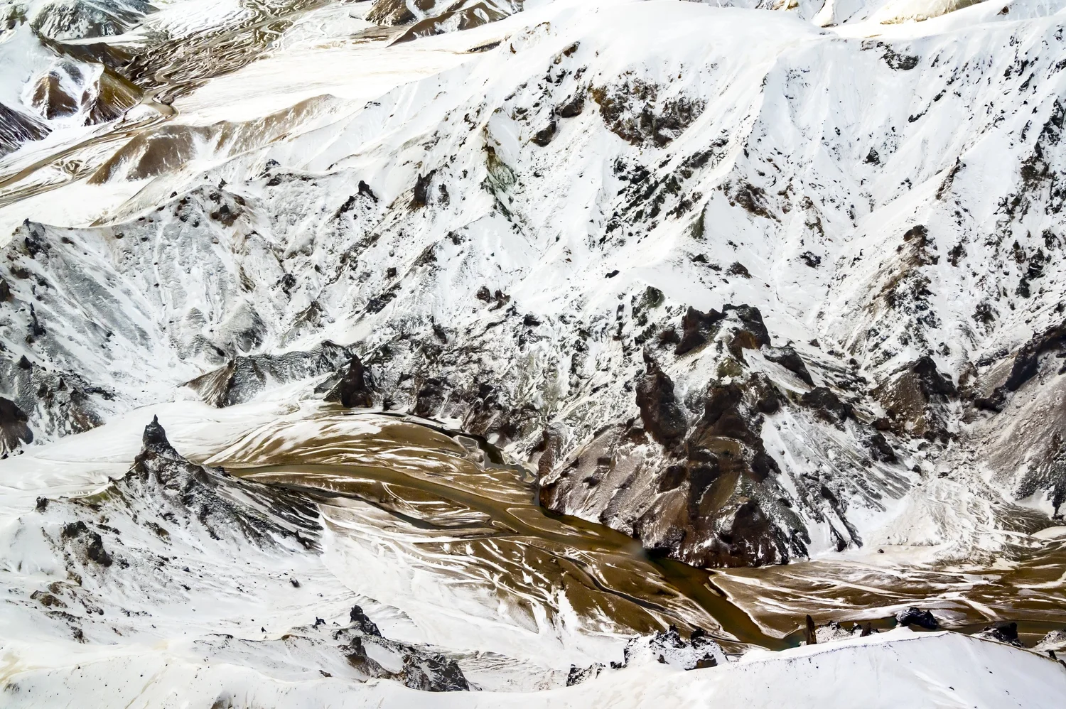 Snow-covered mountain ridges from above, winter aerial photograph of Iceland — travel photography by Janina Laszlo