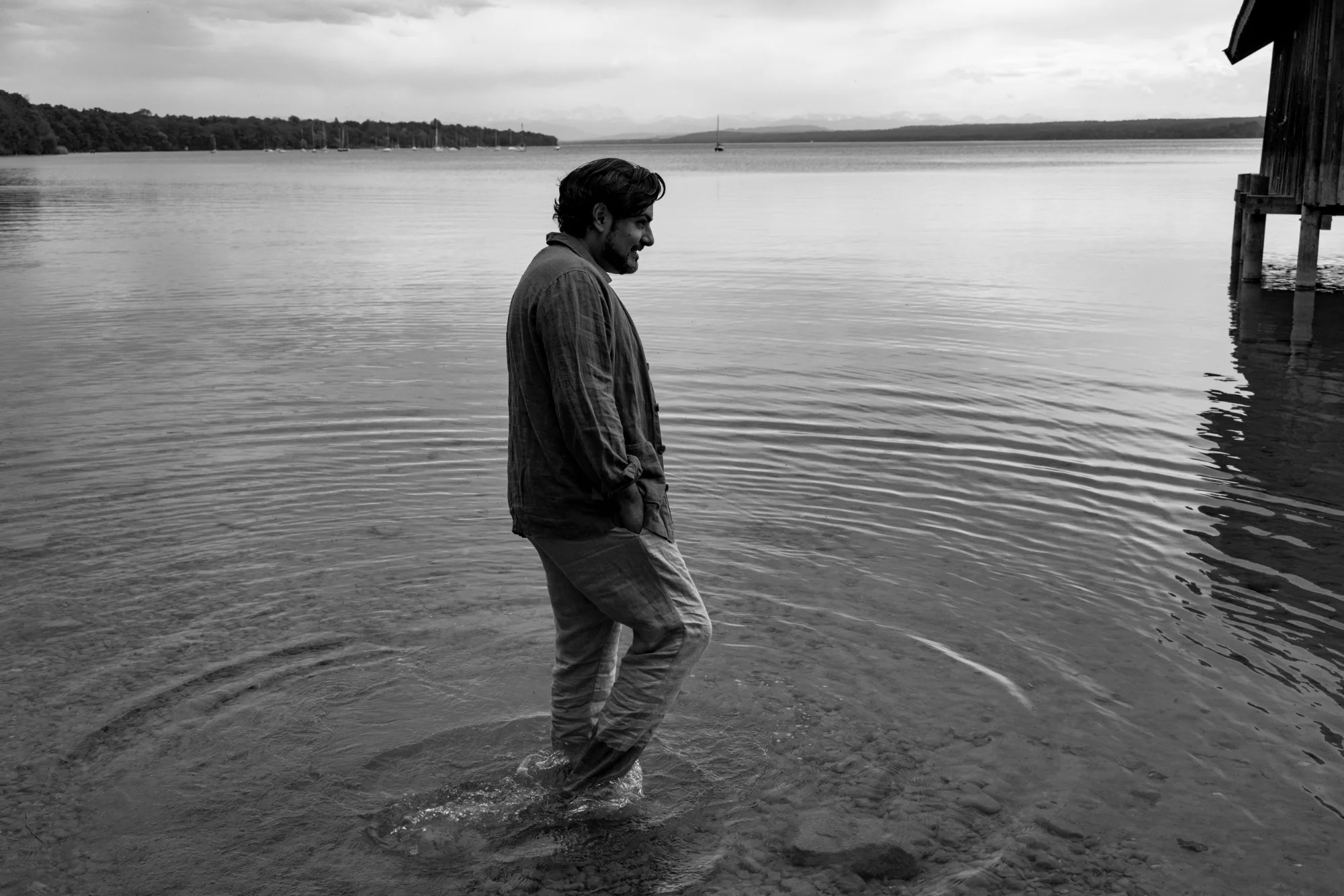 Black-and-white image of Ilker Arcayürek wading in the lake — Ilker Arcayürek, artist portrait photography by Janina Laszlo