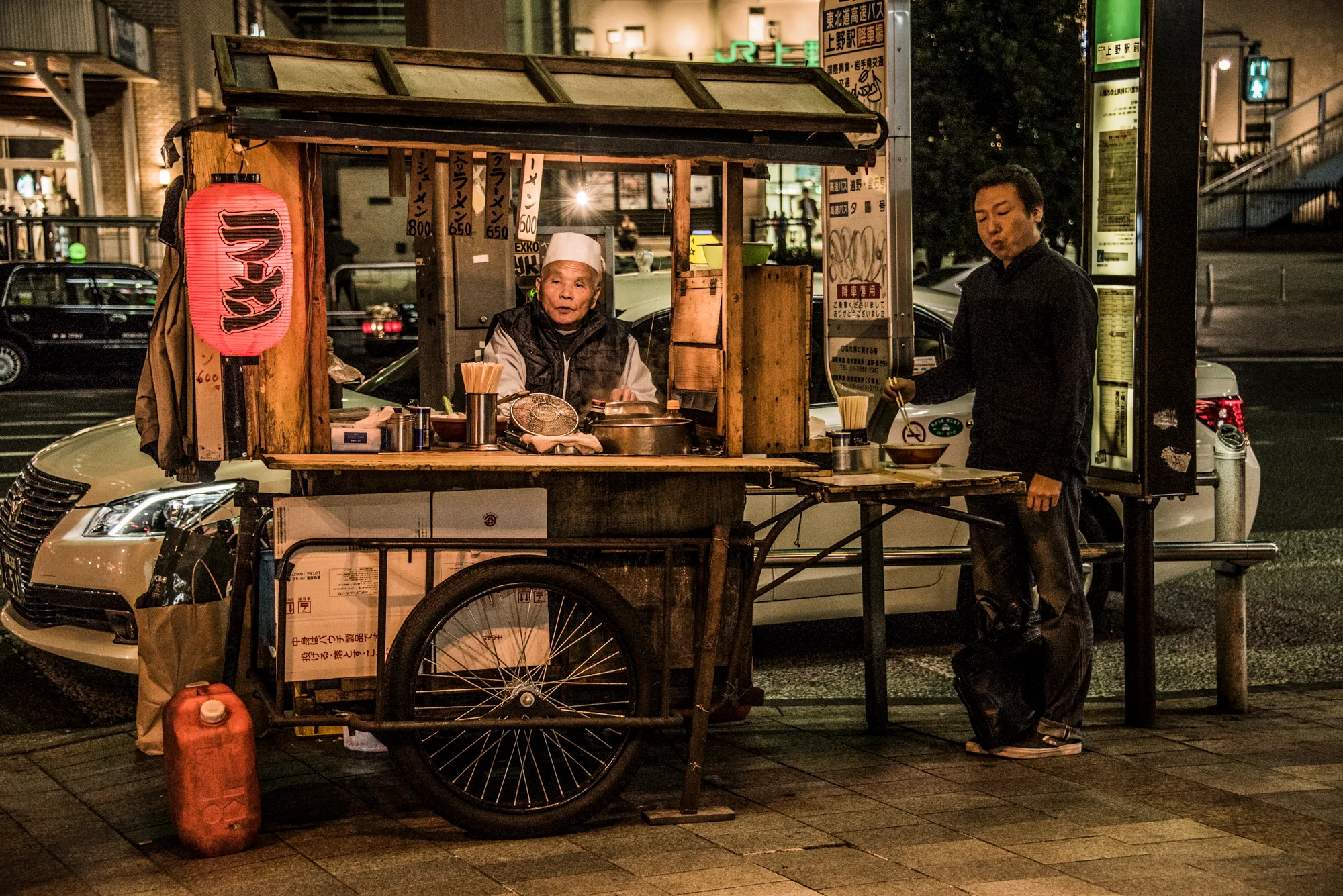 Ramen street stall with a red lantern outside Ueno Station at night, Tokyo — Japan, travel and street photography by Janina Laszlo