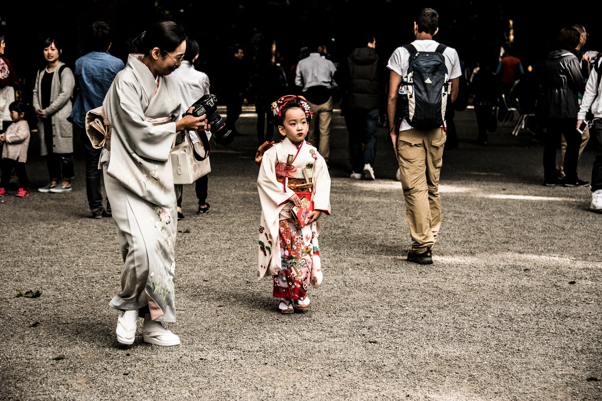 Little girl in a festive kimono walking beside her mother at a shrine, Tokyo — Japan, travel and street photography by Janina Laszlo