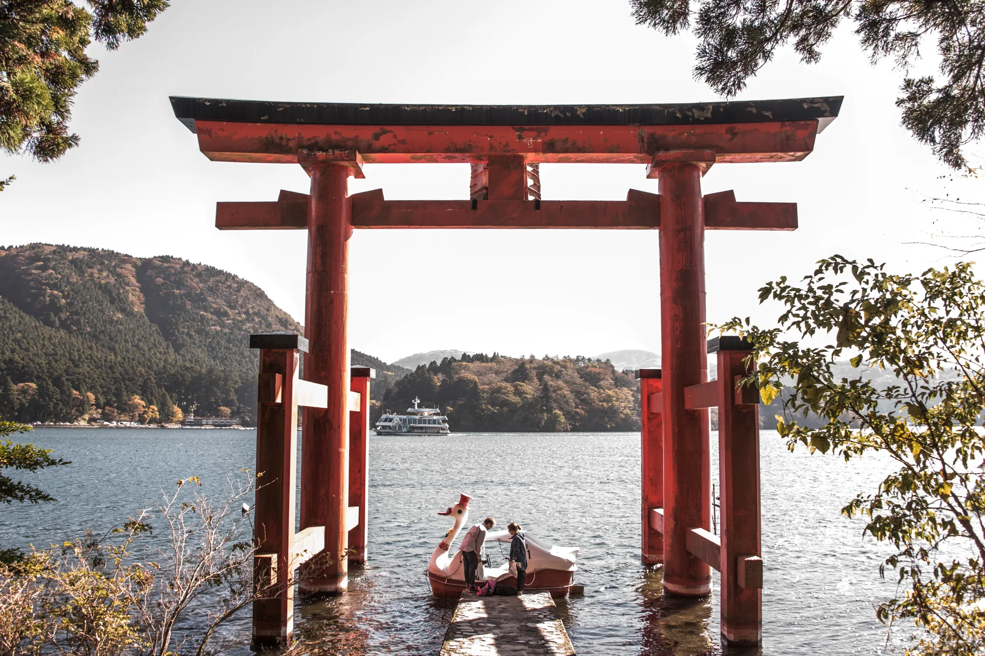 Swan pedal boat beneath the red torii of Hakone Shrine on Lake Ashi, near Mount Fuji — Japan, travel and street photography by Janina Laszlo