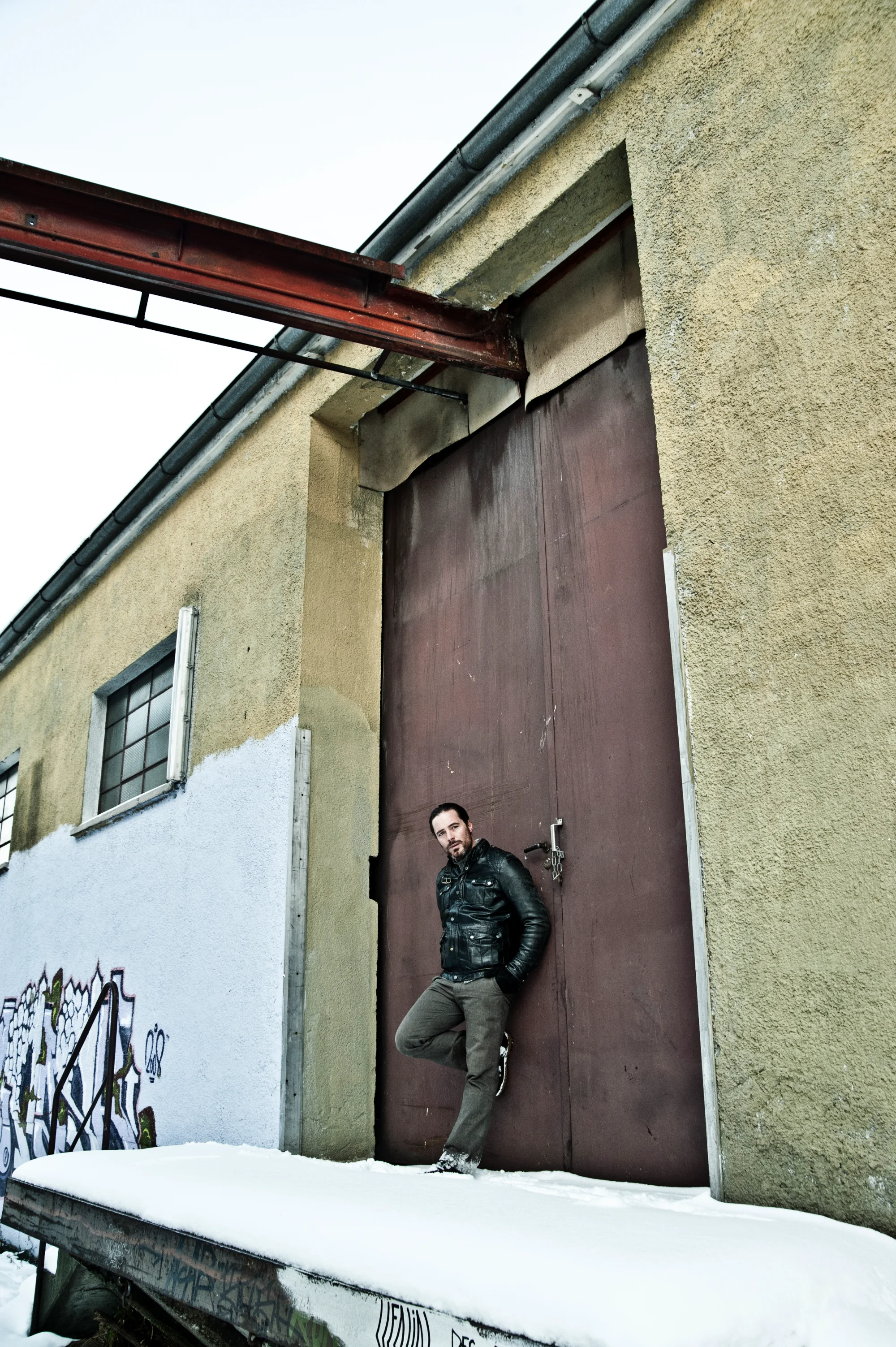 John Friedmann in a snowy courtyard in front of an old wall — John Friedmann, actor portrait photography by Janina Laszlo