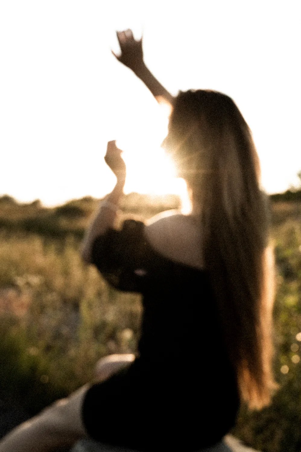 Julia backlit with arms raised in a summer field — Julia, dance portrait photography by Janina Laszlo