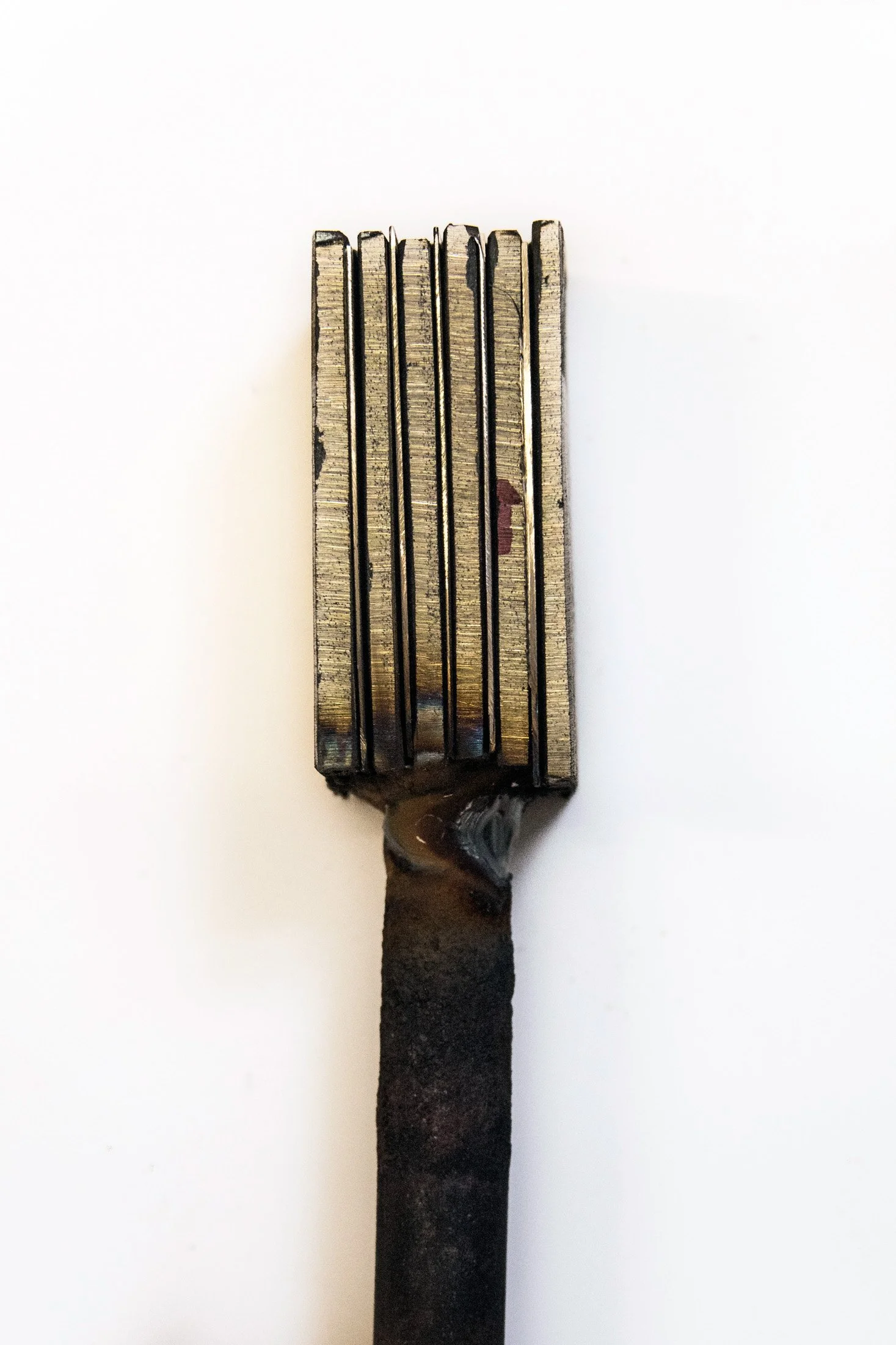 Hand-forged blade blank with pattern-welded steel on a white background — reportage by Janina Laszlo, photographer in Munich