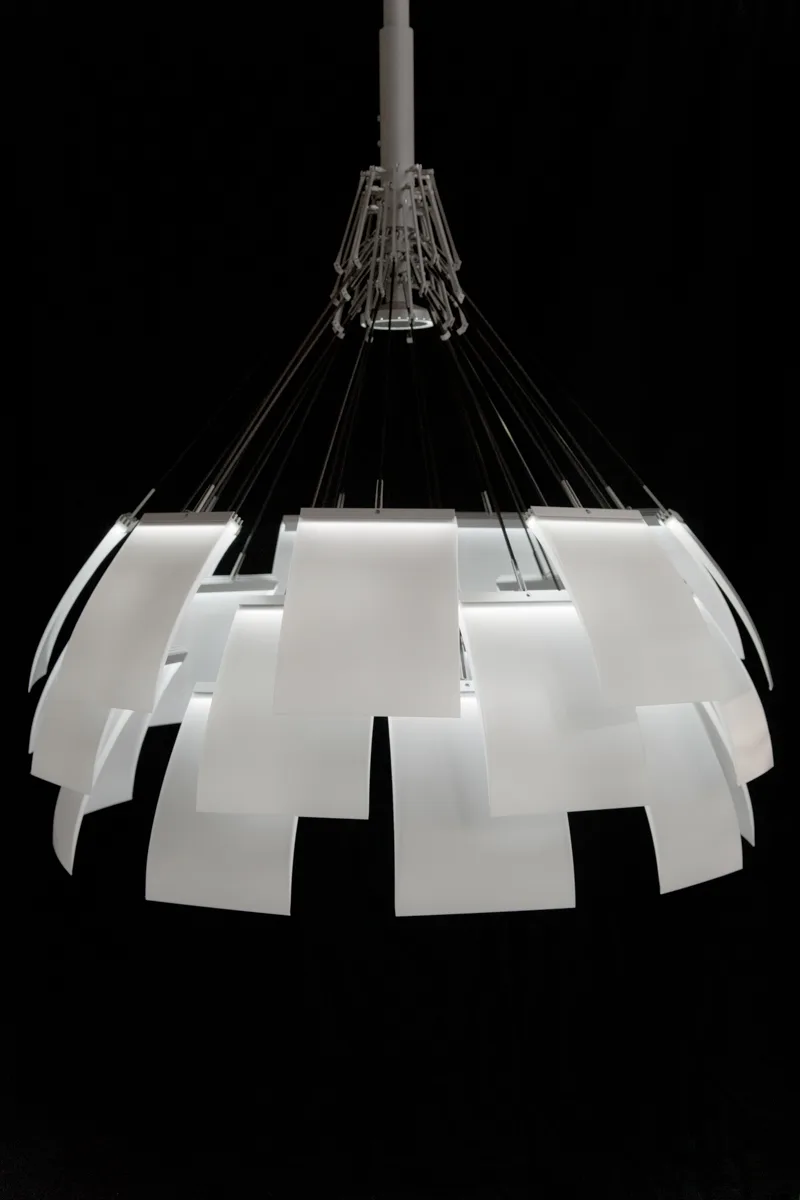 The complete LC 1 chandelier with layered white light panels and its mechanical crown, black background — LC 1.0 chandelier by Denise M. Hachinger, product and design photography by Janina Laszlo