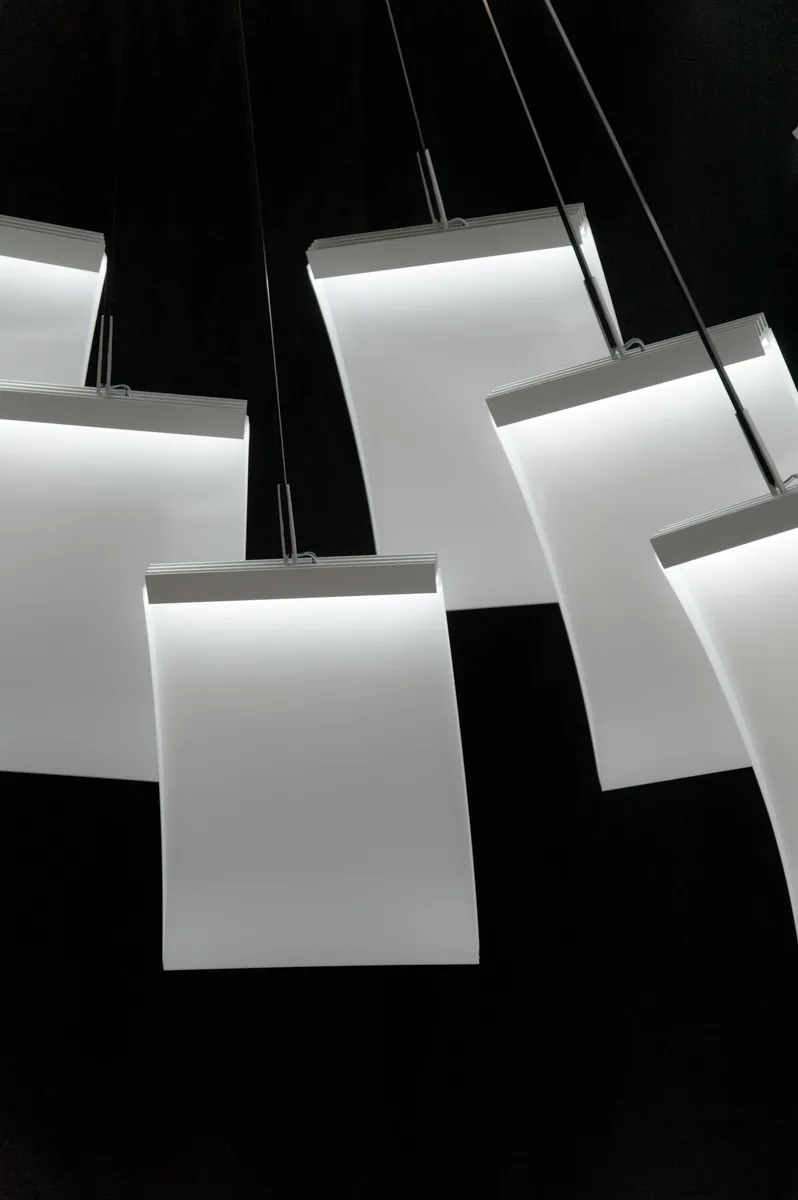 White light panels of the LC 1.0 chandelier hanging on fine rods in the dark — LC 1.0 chandelier by Denise M. Hachinger, product and design photography by Janina Laszlo