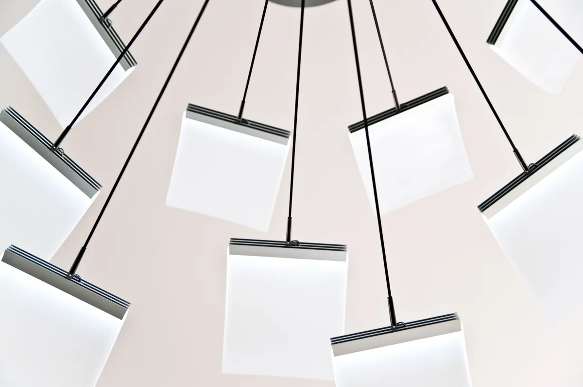 Square light panels of the LC 1.0 chandelier fanning out on black rods, seen from below — LC 1.0 chandelier by Denise M. Hachinger, product and design photography by Janina Laszlo