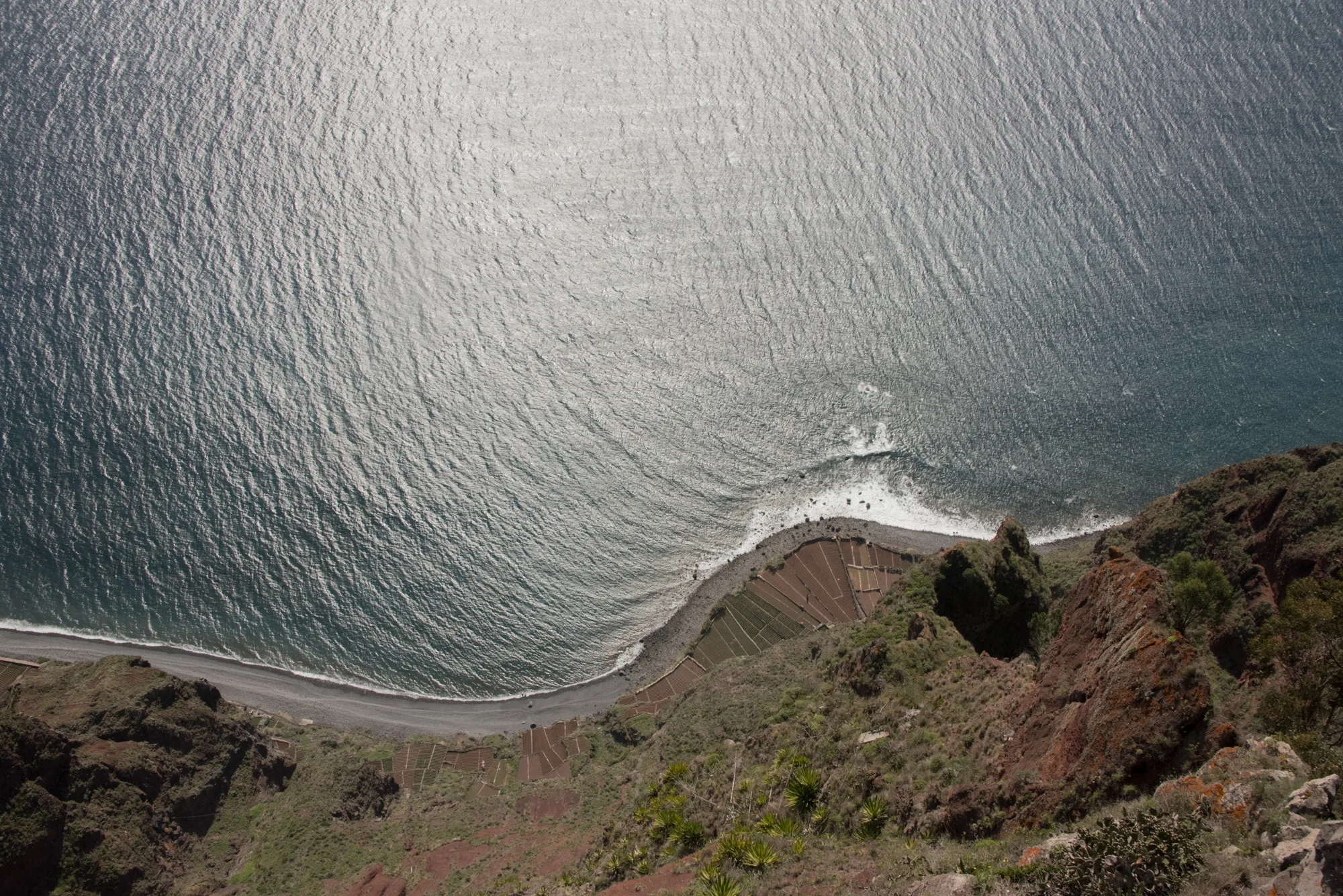 Looking straight down from Cabo Girão onto terraced fields and the beach far below — Madeira, landscape and travel photography by Janina Laszlo
