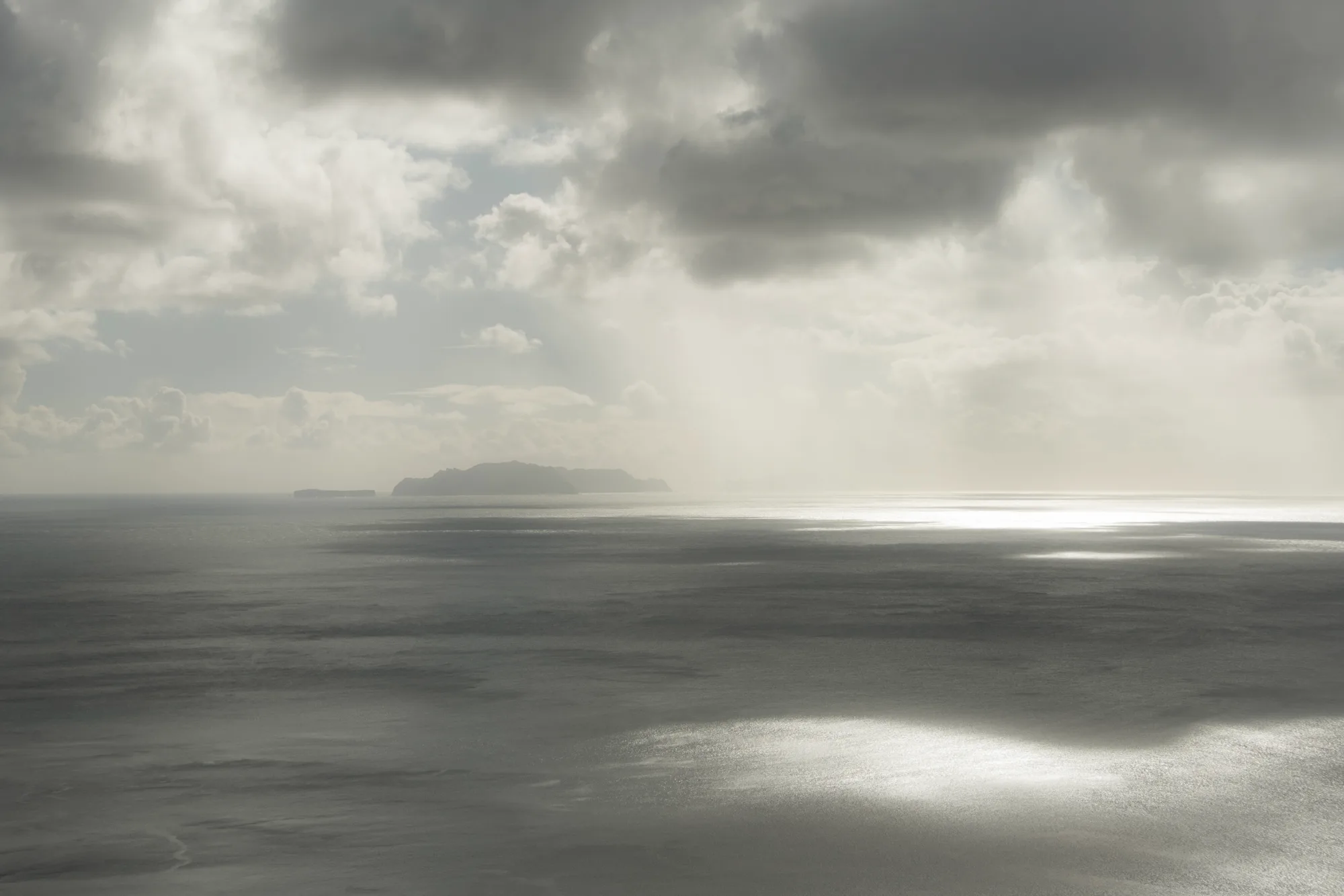 Sunlight on the Atlantic with island silhouettes on the horizon — Madeira, landscape and travel photography by Janina Laszlo