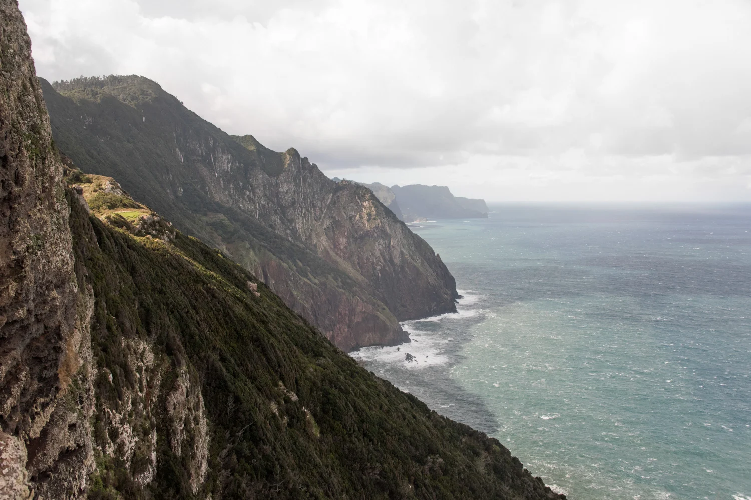 Steep green cliffs of the north coast falling into a wind-whipped Atlantic, Madeira — Madeira, travel and landscape photography by Janina Laszlo