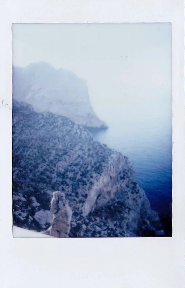 Polaroid of a misty coastal headland and steep cliffs above the sea, Mallorca — Mallorca Polaroids, analog travel photography by Janina Laszlo