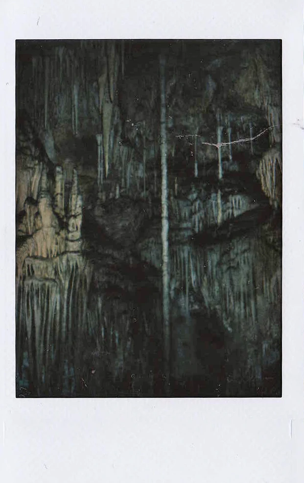 Polaroid of dripstone stalactites in a dark limestone cave, Mallorca — Mallorca Polaroids, analog travel photography by Janina Laszlo