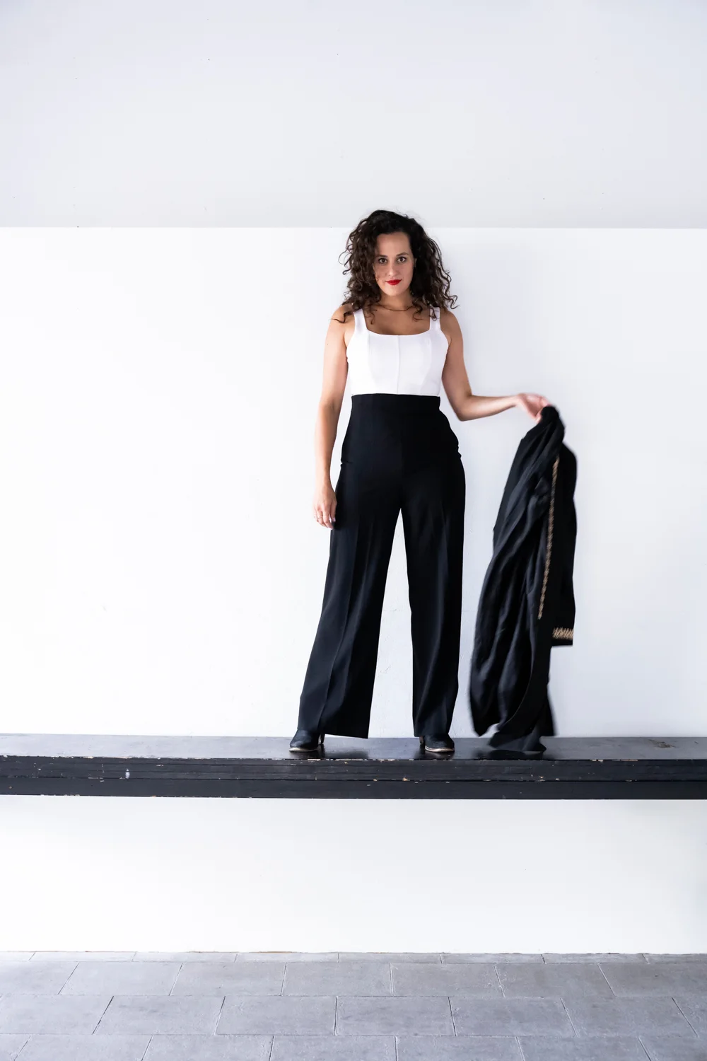 Marie Seidler in black trousers in a white studio — Marie Seidler, mezzo-soprano, opera portrait photography by Janina Laszlo