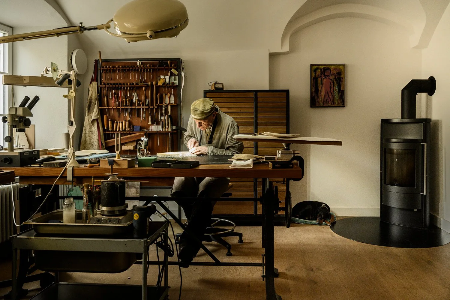The violin making workshop in Landsberg am Lech with workbench, tools and stove — Martin Schleske, master violin maker, editorial portrait and documentary photography by Janina Laszlo, Landsberg am Lech