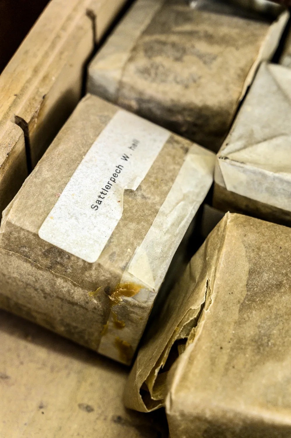 Packages of saddler pitch wrapped in paper, labelled by hand — Michael Ruoff, master saddler, editorial portrait and craftsmanship photography by Janina Laszlo