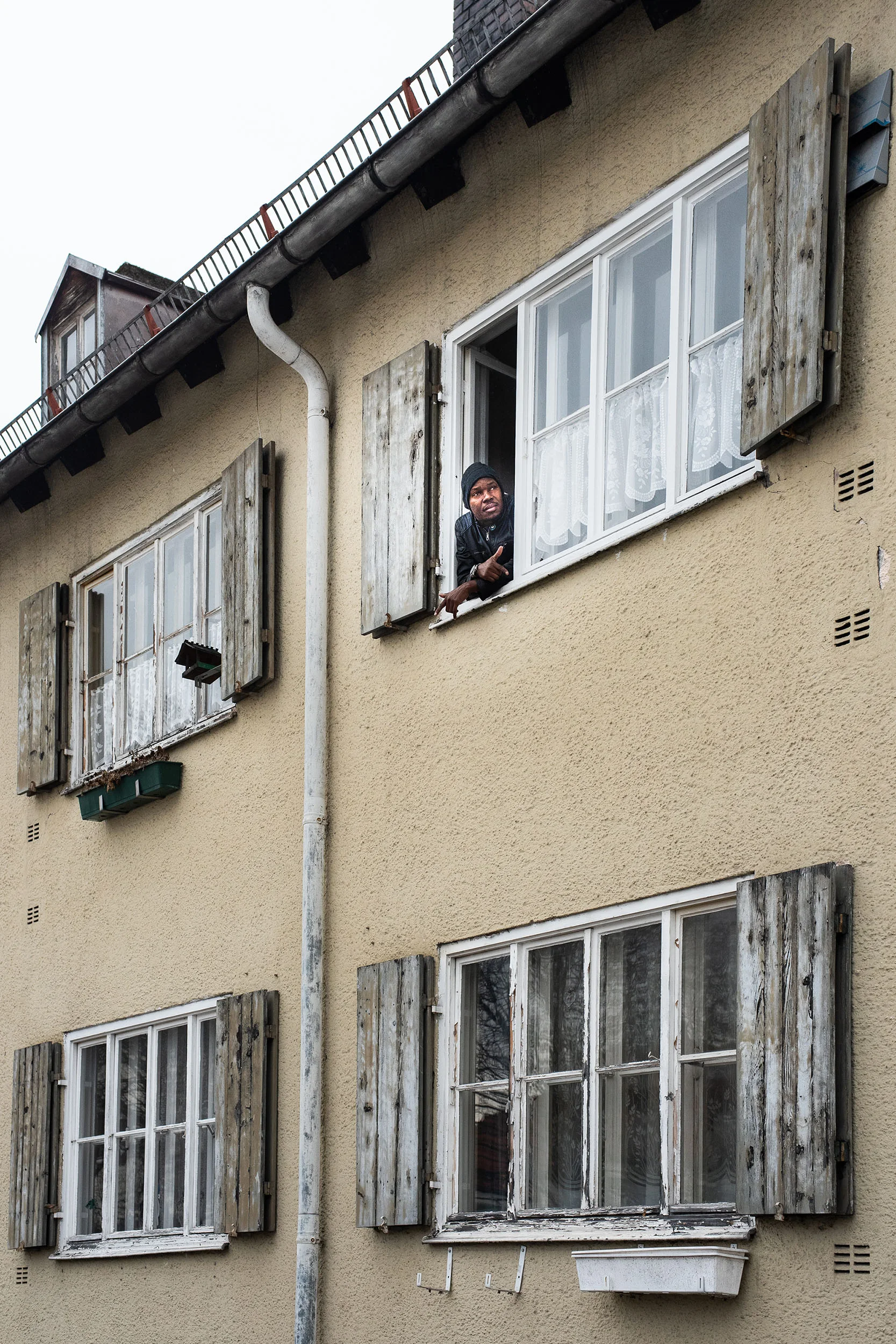 Facade of an apartment building with shutters — MOSES, editorial portrait photography by Janina Laszlo