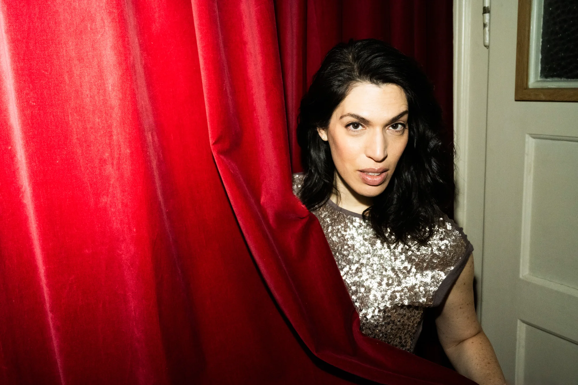 Na’ama Goldman in a sequin dress against a red velvet curtain — Na’ama Goldman, mezzo-soprano, opera portrait photography by Janina Laszlo