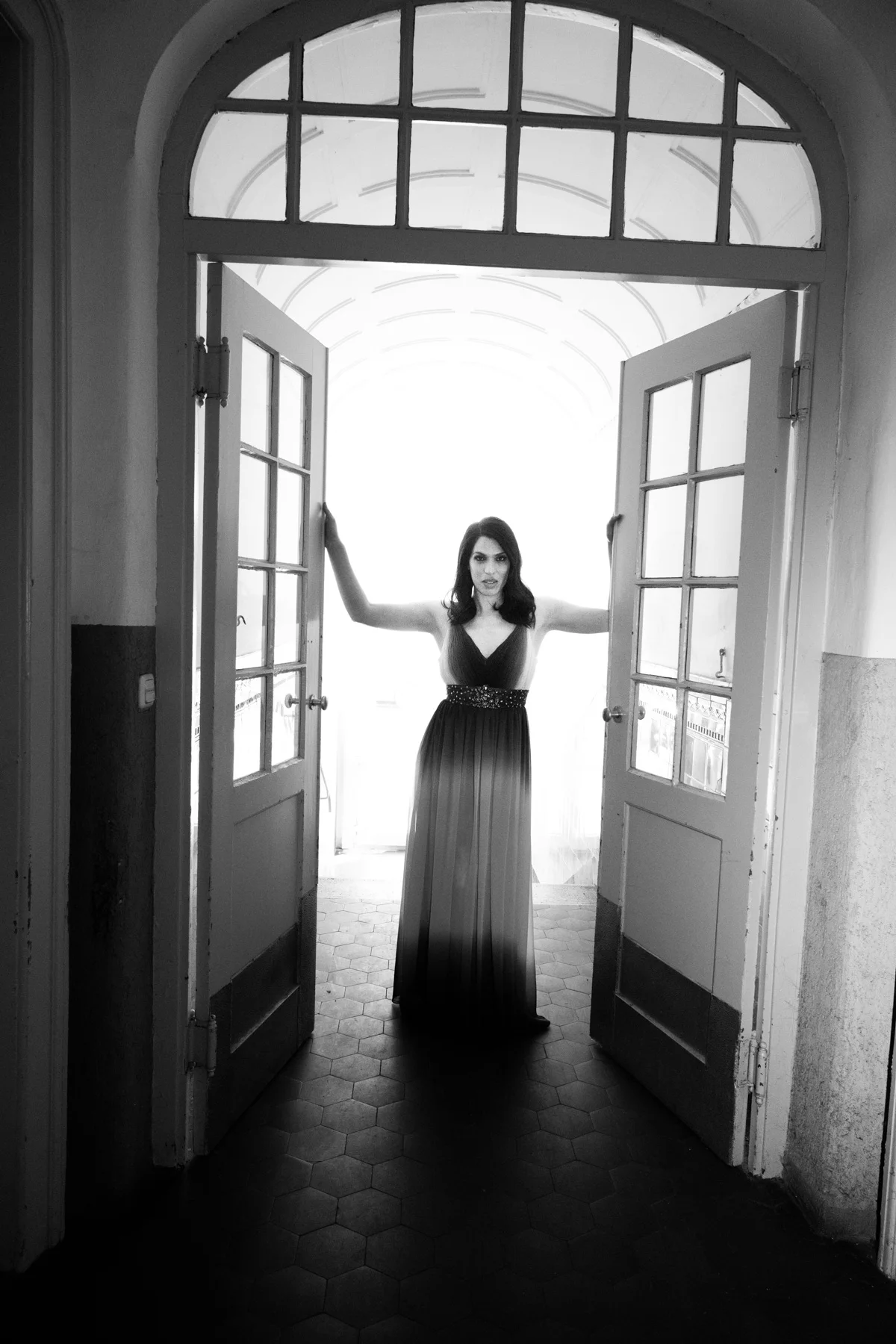 Na’ama Goldman in a long dress in a bright doorway — Na’ama Goldman, mezzo-soprano, opera portrait photography by Janina Laszlo