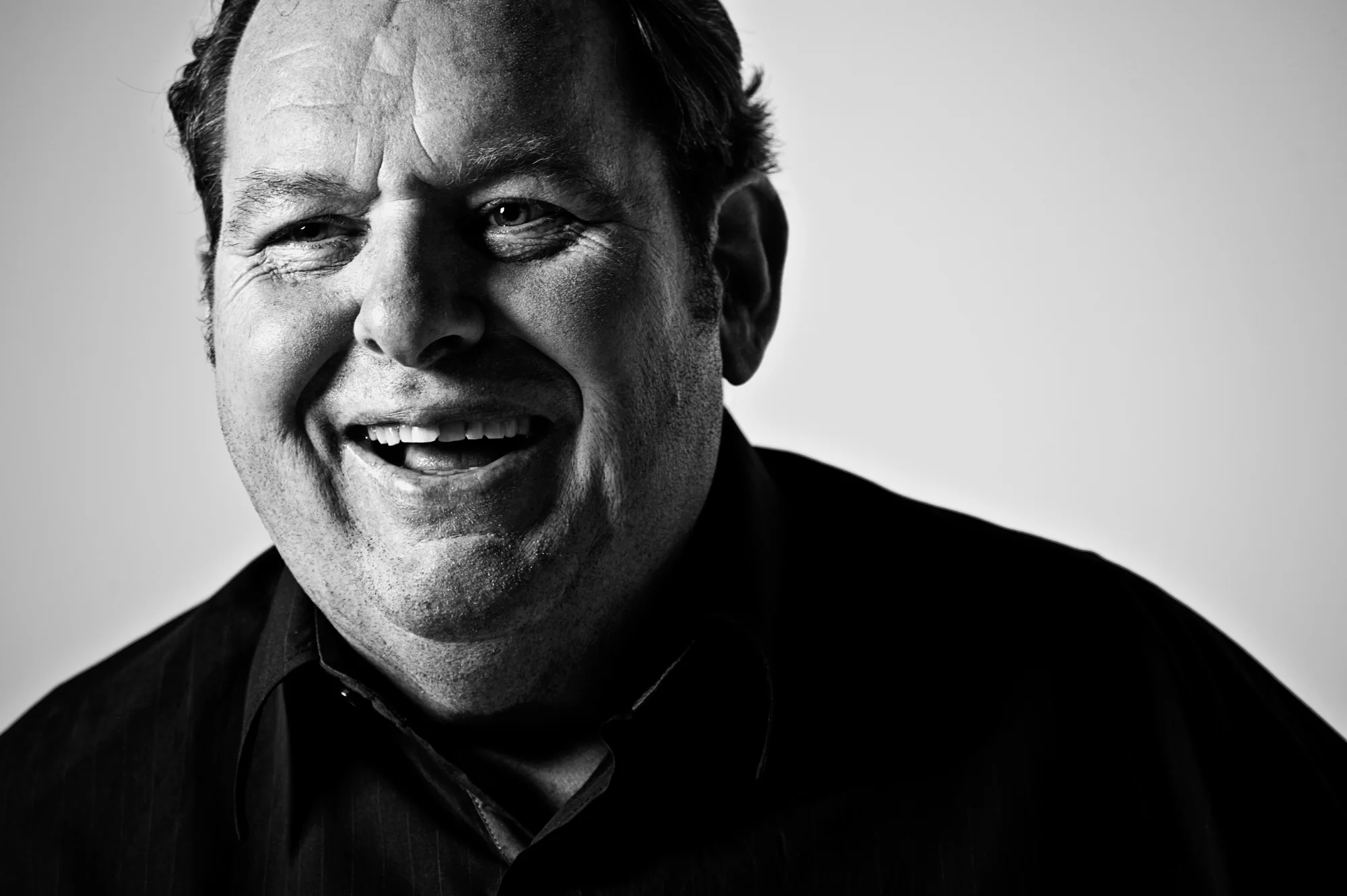 Black-and-white portrait of Ottfried Fischer laughing — Ottfried Fischer, celebrity portrait photography by Janina Laszlo
